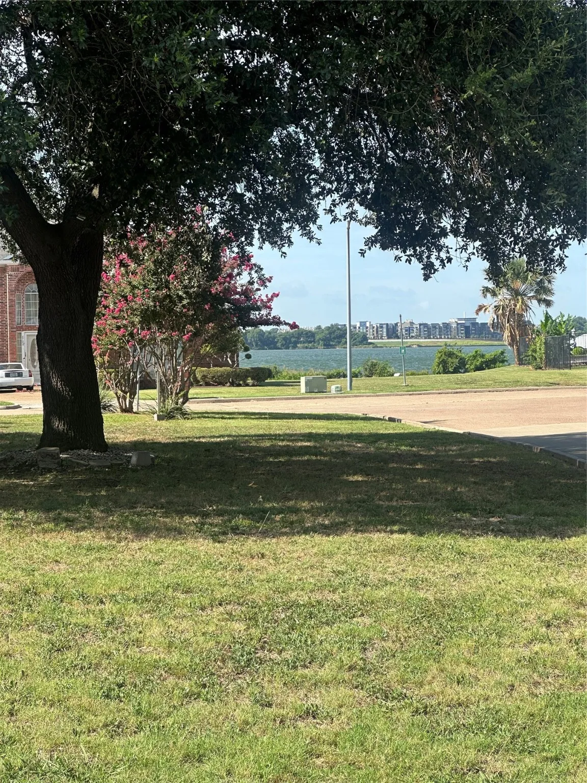 View of grassy yard and Lake Ray Hubbard from back porch area