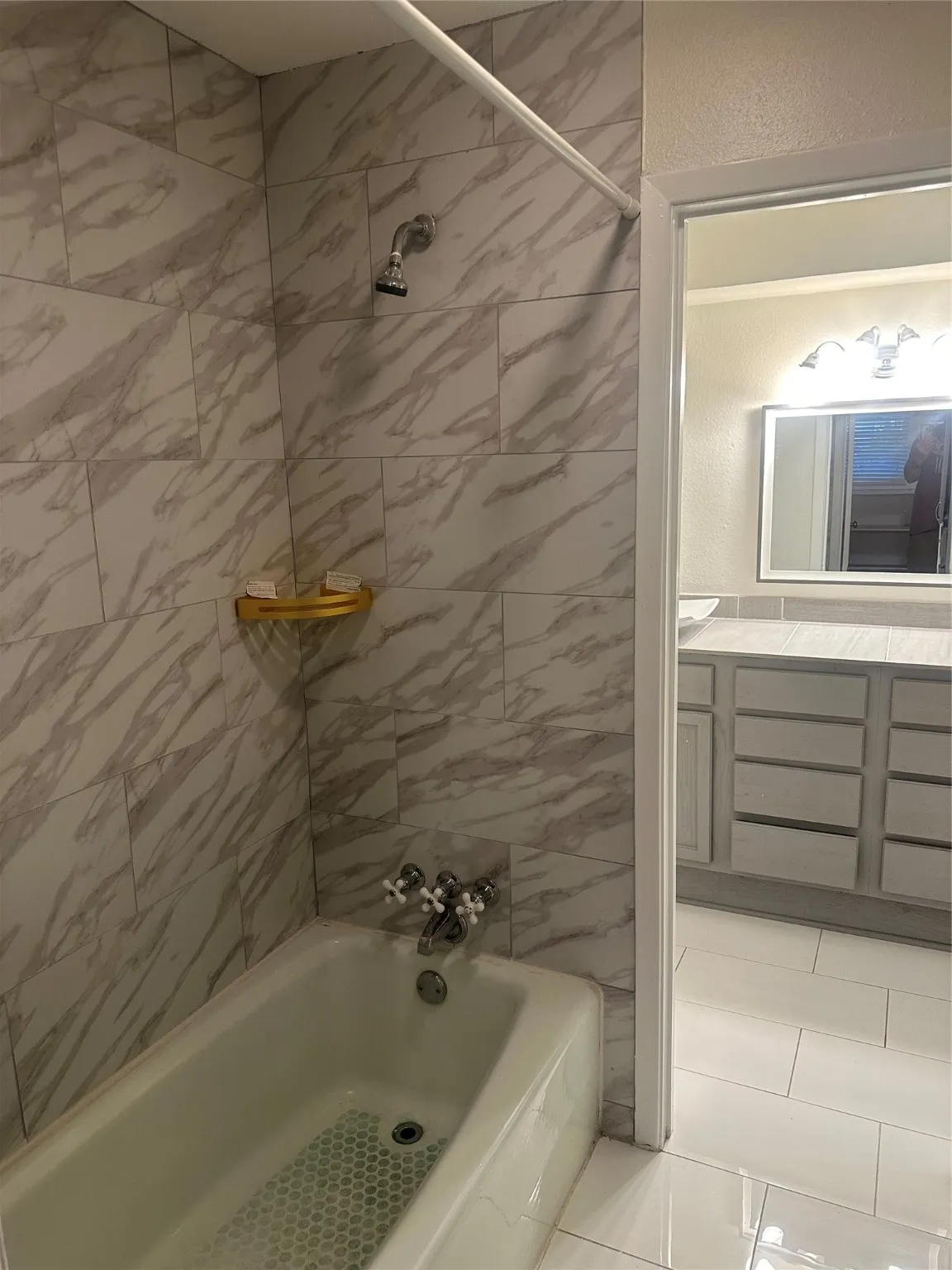 Full bathroom featuring washtub / shower combination and vanity