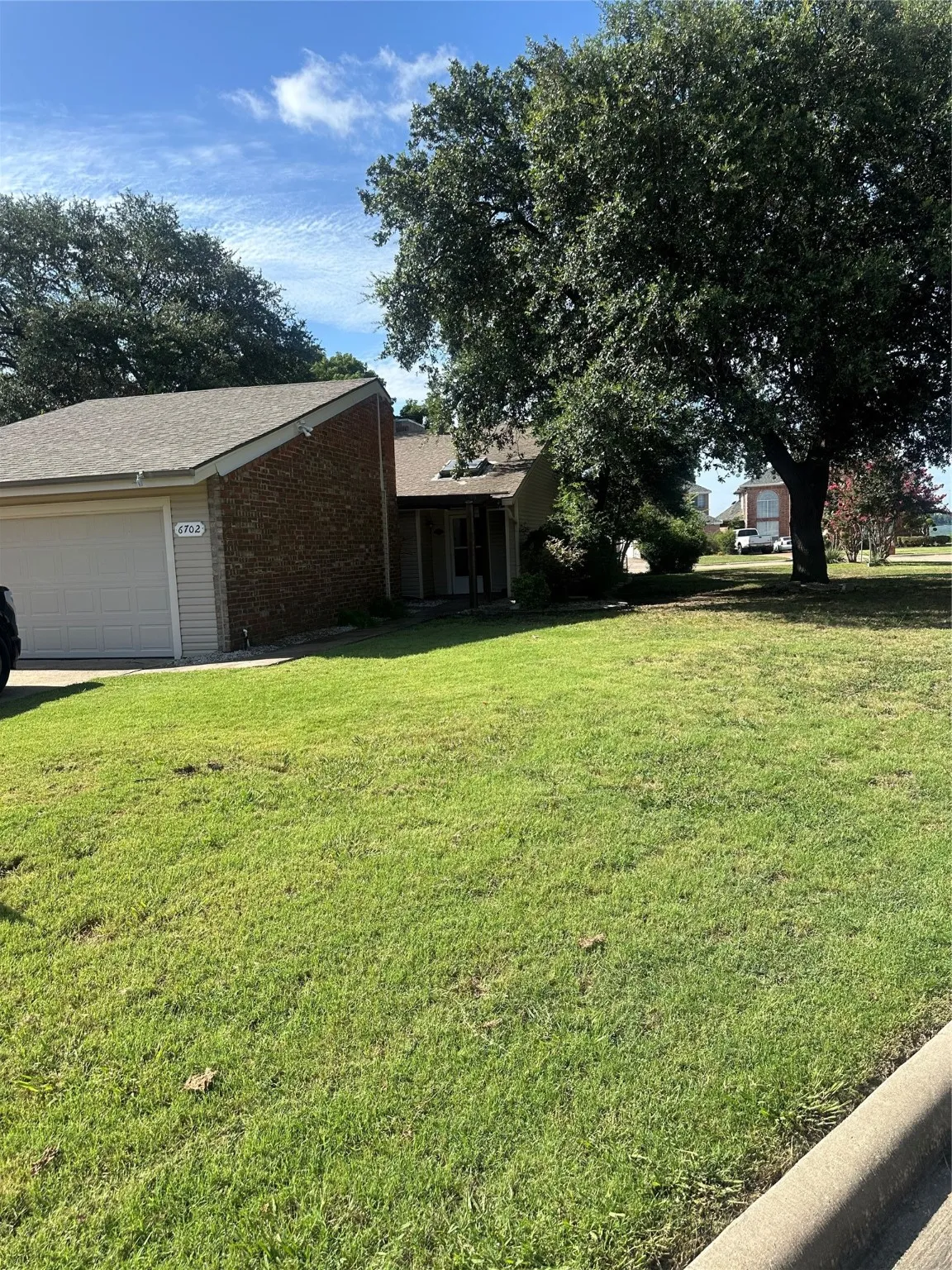 View of grassy yard with an attached garage