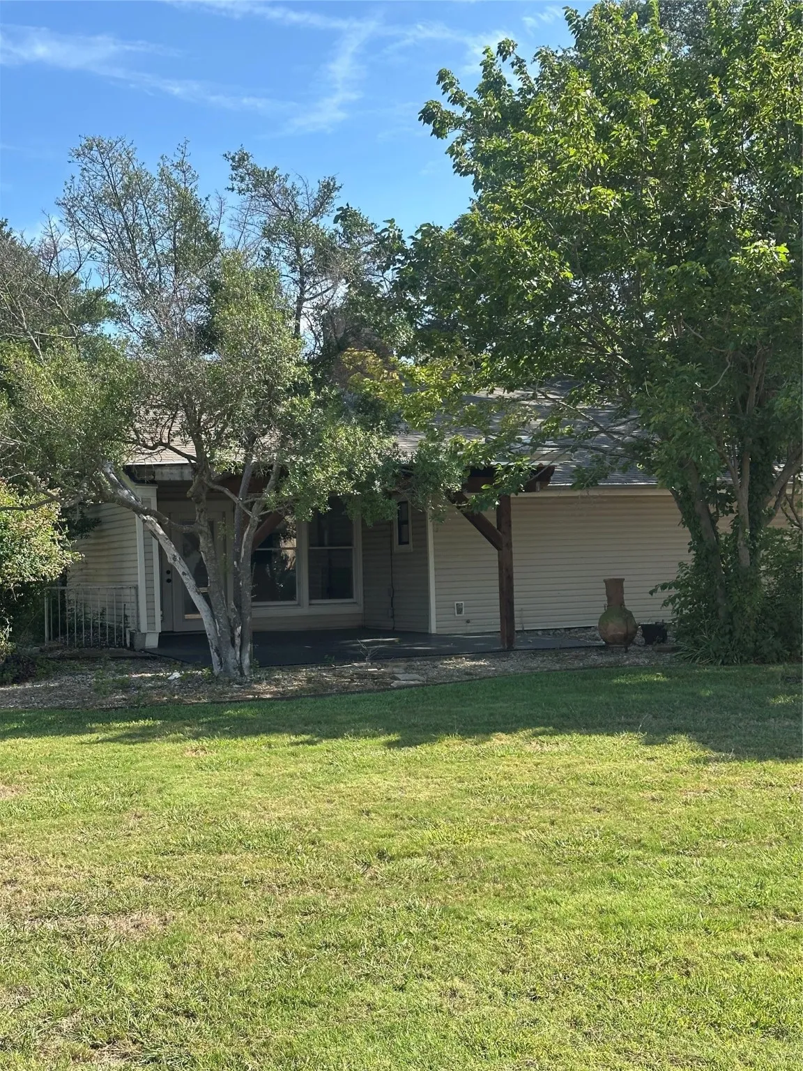 Patio, backyard view of property featuring a front lawn and a patio area