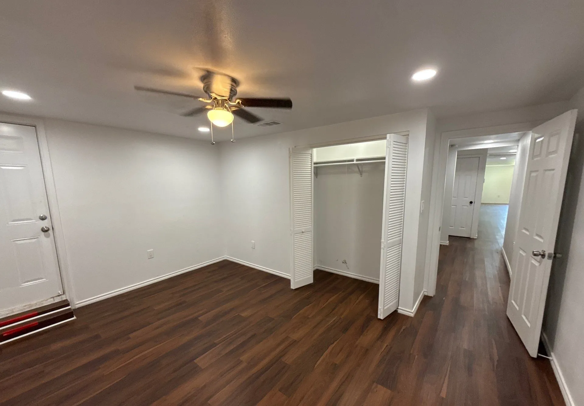 Unfurnished bedroom featuring dark wood finished floors, recessed lighting, a closet, and a ceiling fan
