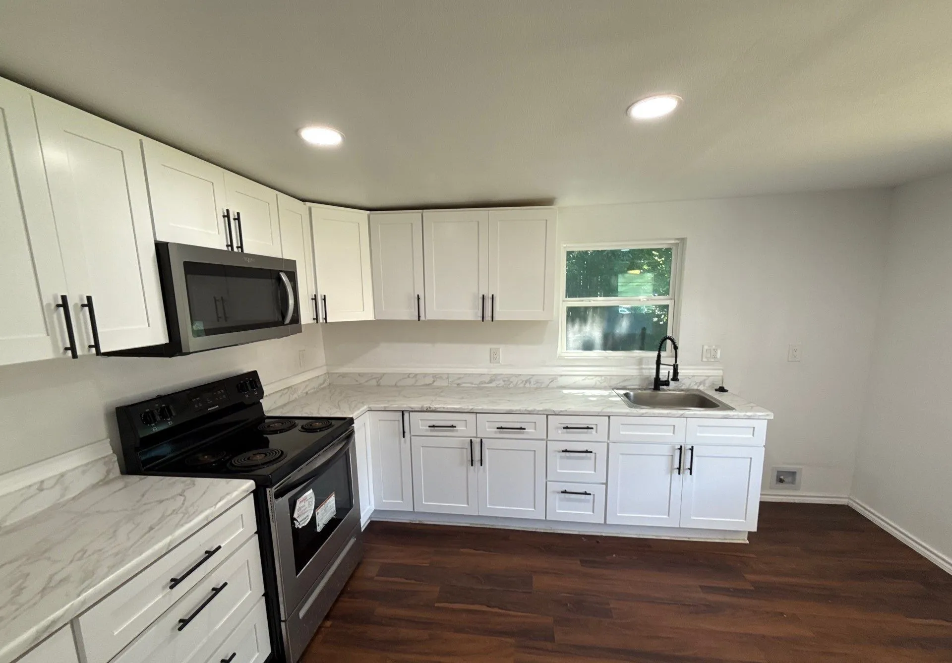 Kitchen featuring electric stove, stainless steel microwave, white cabinetry, recessed lighting, and dark wood-style flooring