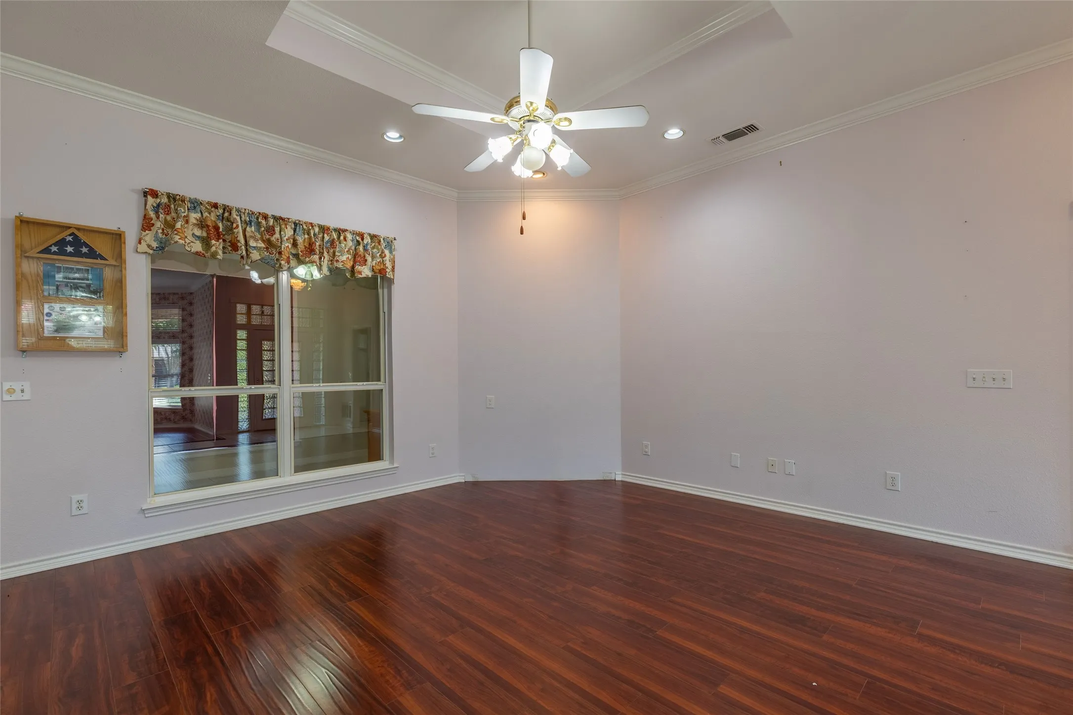 Empty room featuring ornamental molding, wood-type flooring, recessed lighting, and a ceiling fan