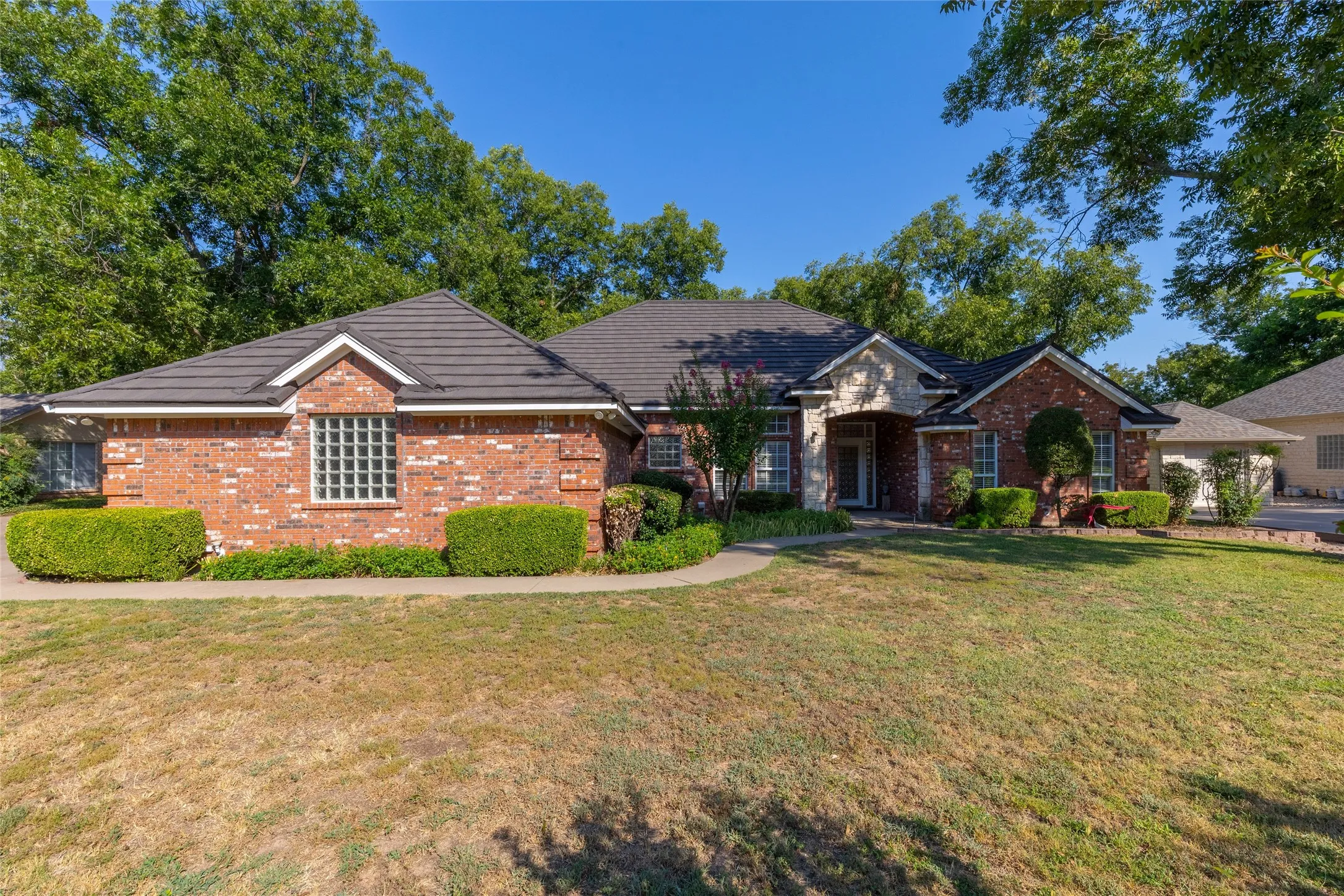 View of front of house featuring brick siding and a front lawn