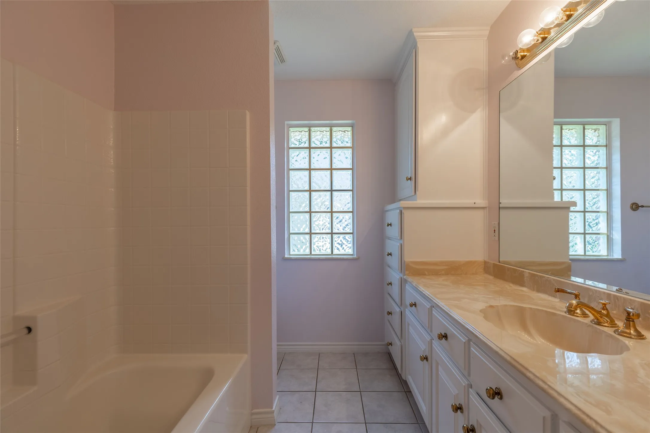 Bathroom with tile patterned floors, vanity, and shower / bath combination