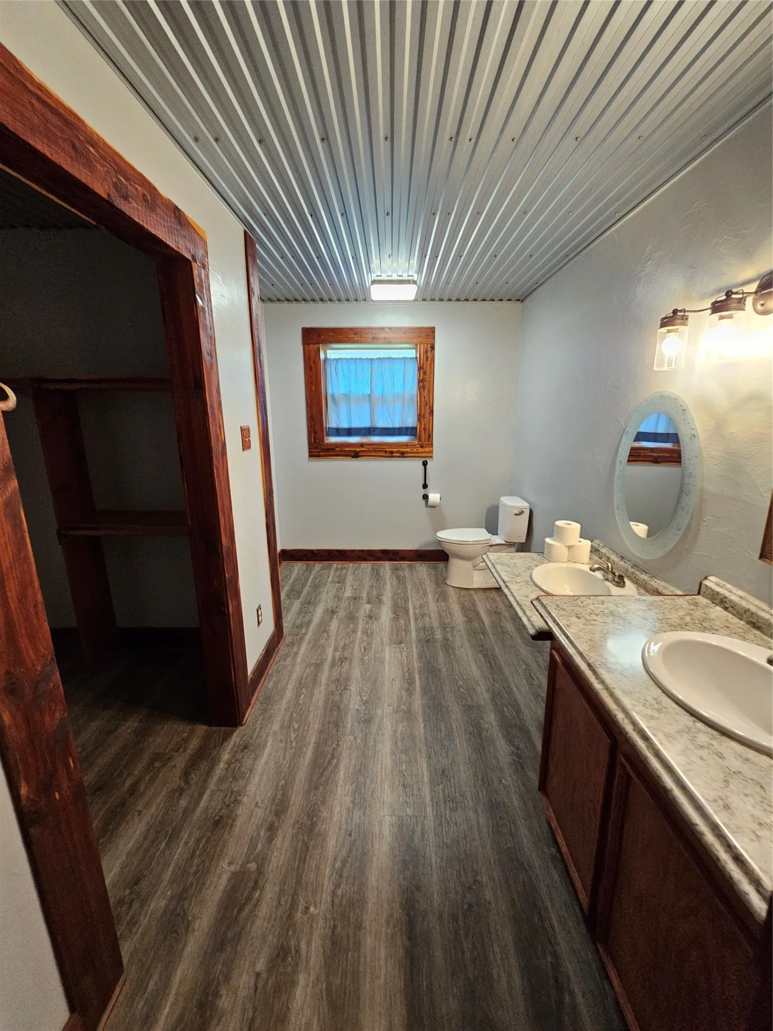 Bathroom featuring wood finished floors and double vanity