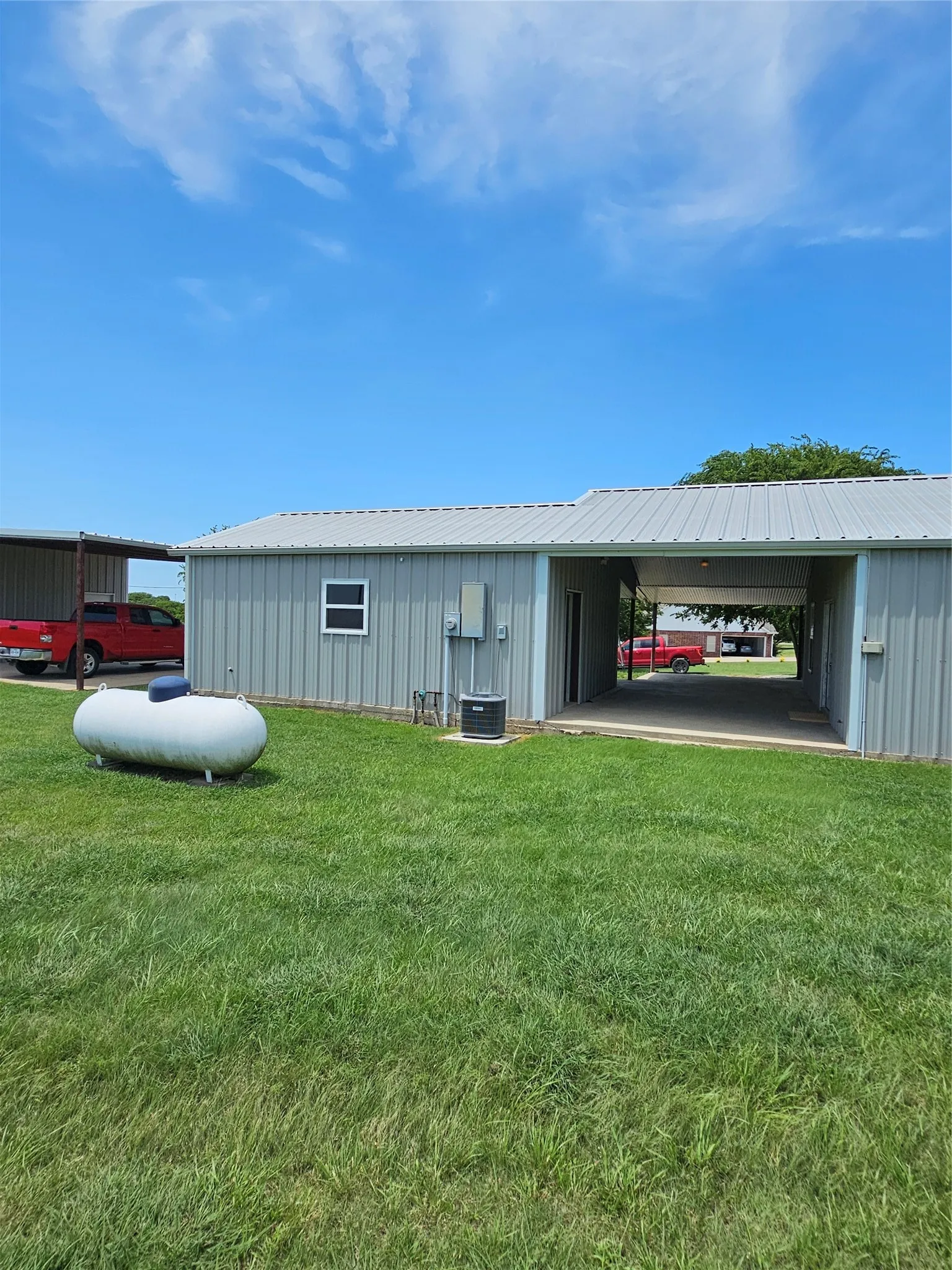 Back yard, propane tank, tankless water heater.