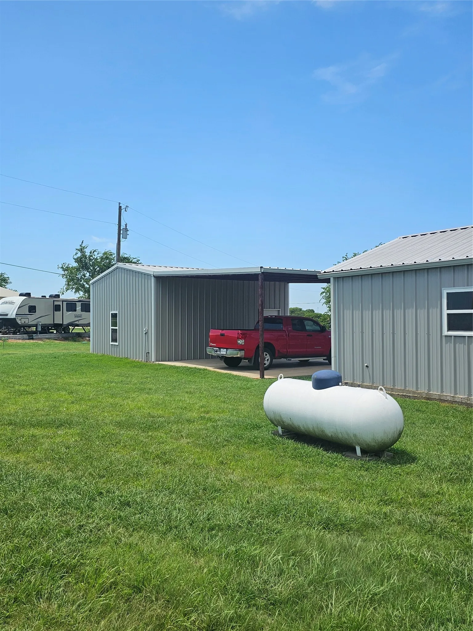 Back of house, Carport, and shop.