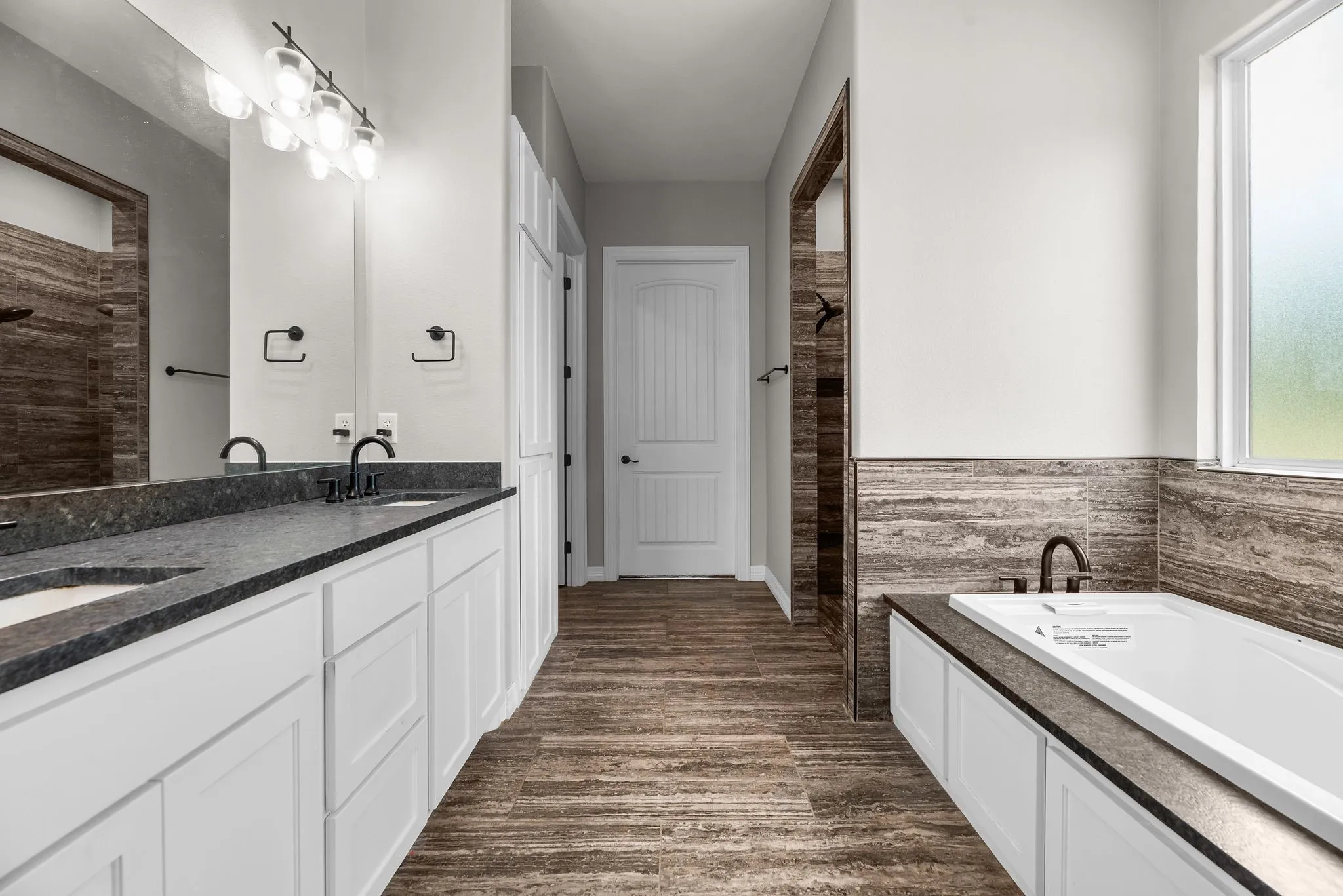 The primary ensuite bath features dual sink and plenty of space to store away everything.