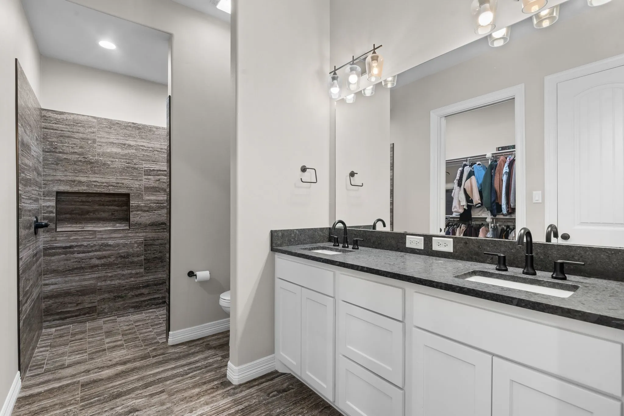 Ensuite bath with walk in shower and dual sinks.