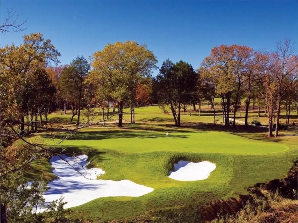 View of home's community featuring an area to practice putting and golf course view