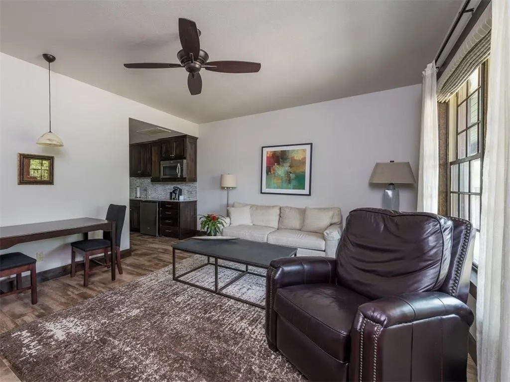 Living area with wood finished floors and a ceiling fan