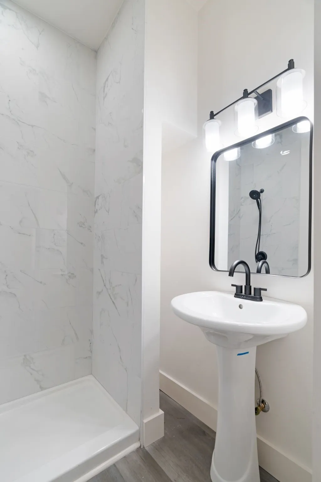 Bathroom featuring wood finished floors and a walk in shower