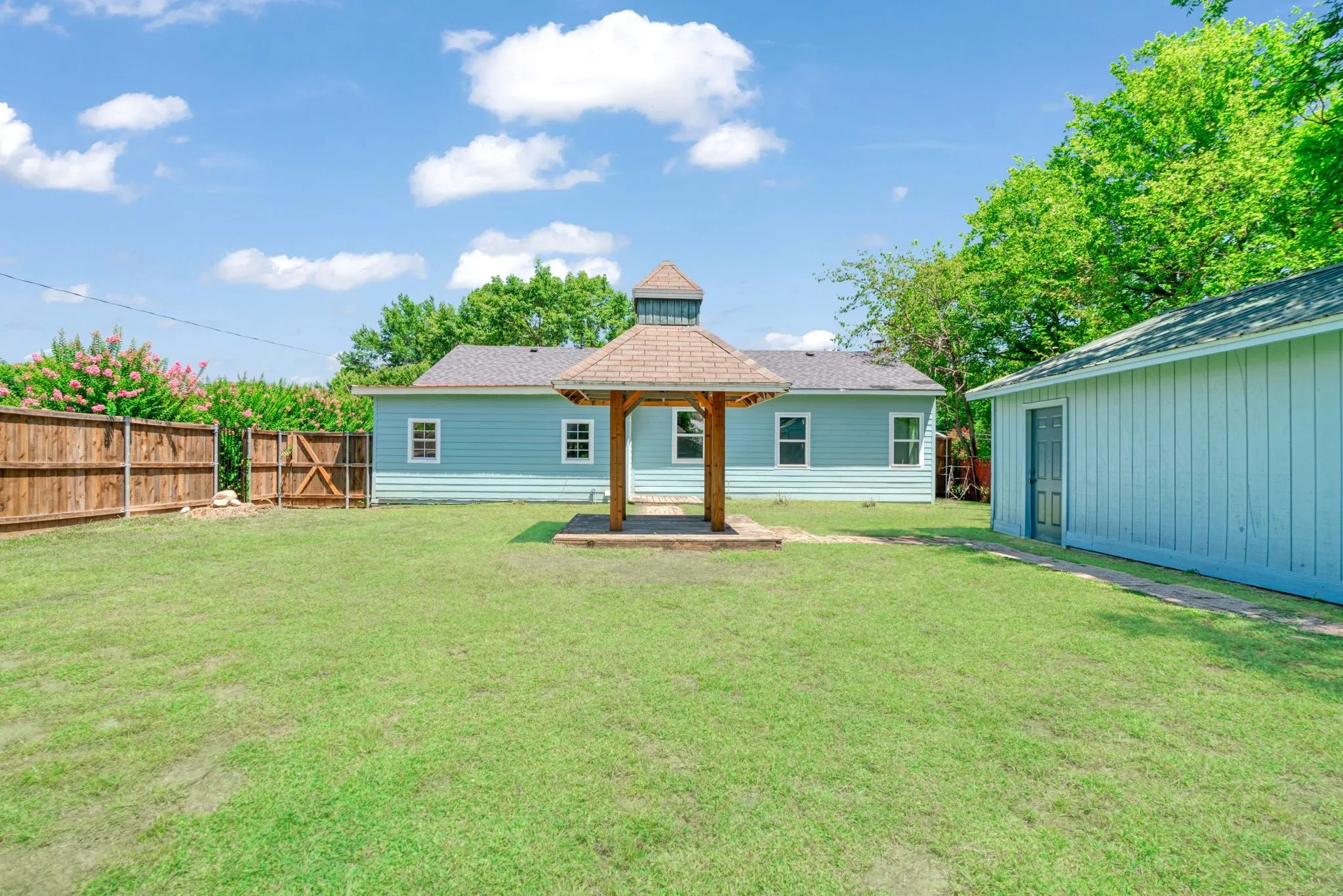 Back of property with a gazebo