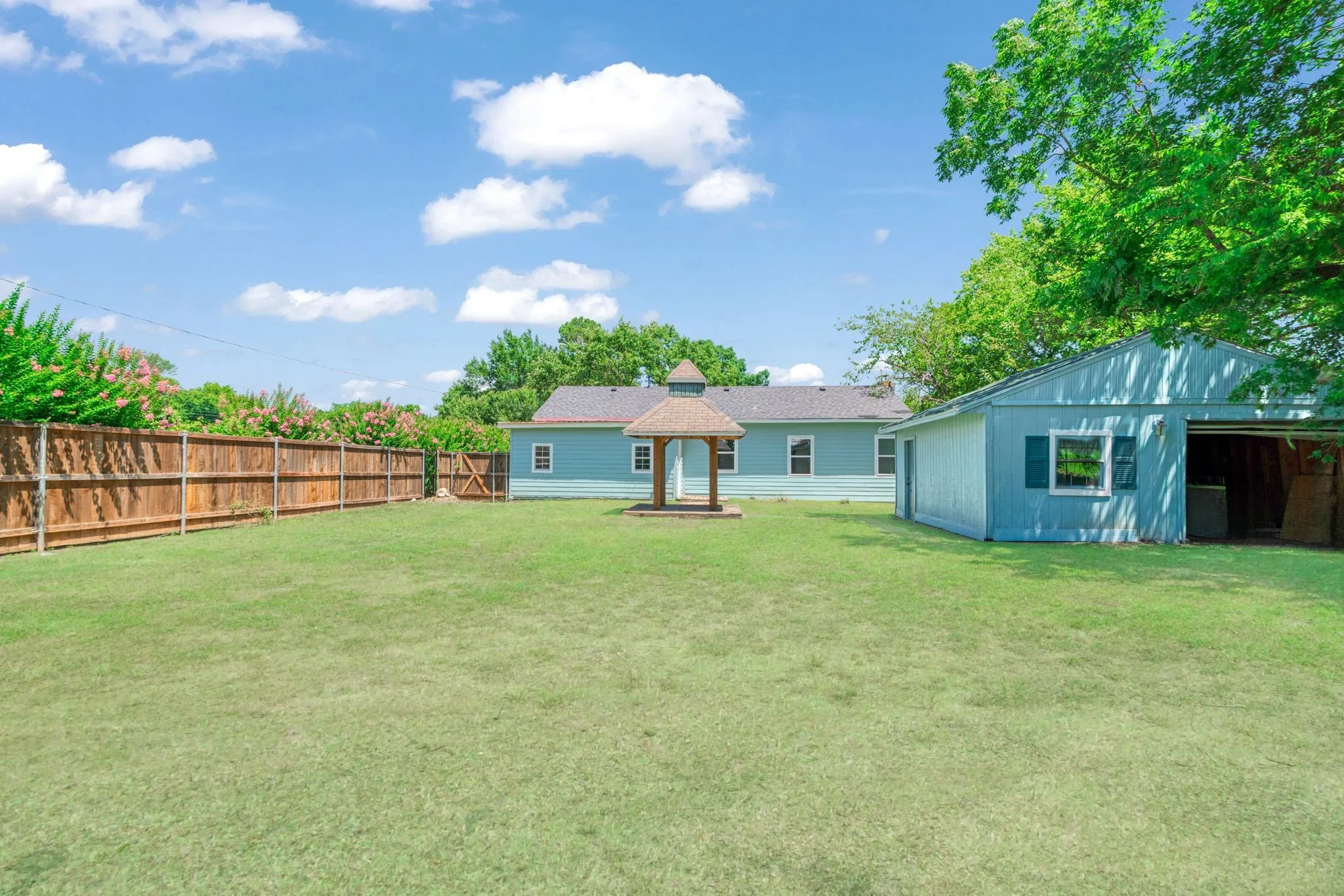 Back of property featuring a gazebo