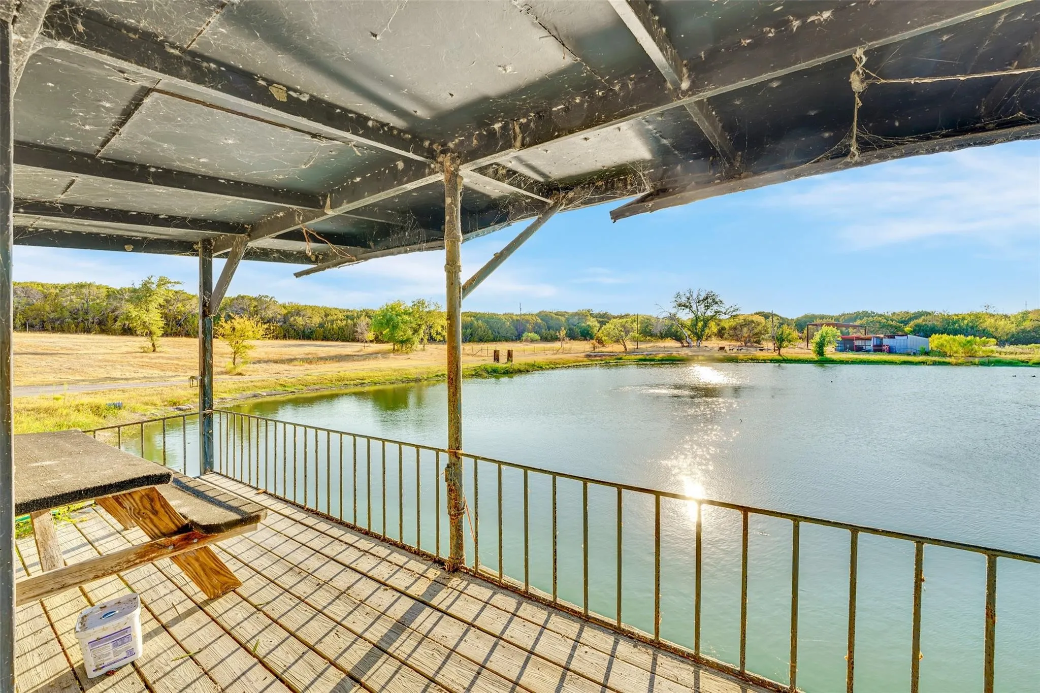 Wooden deck with a water view and view from your new favorite fishing spot.