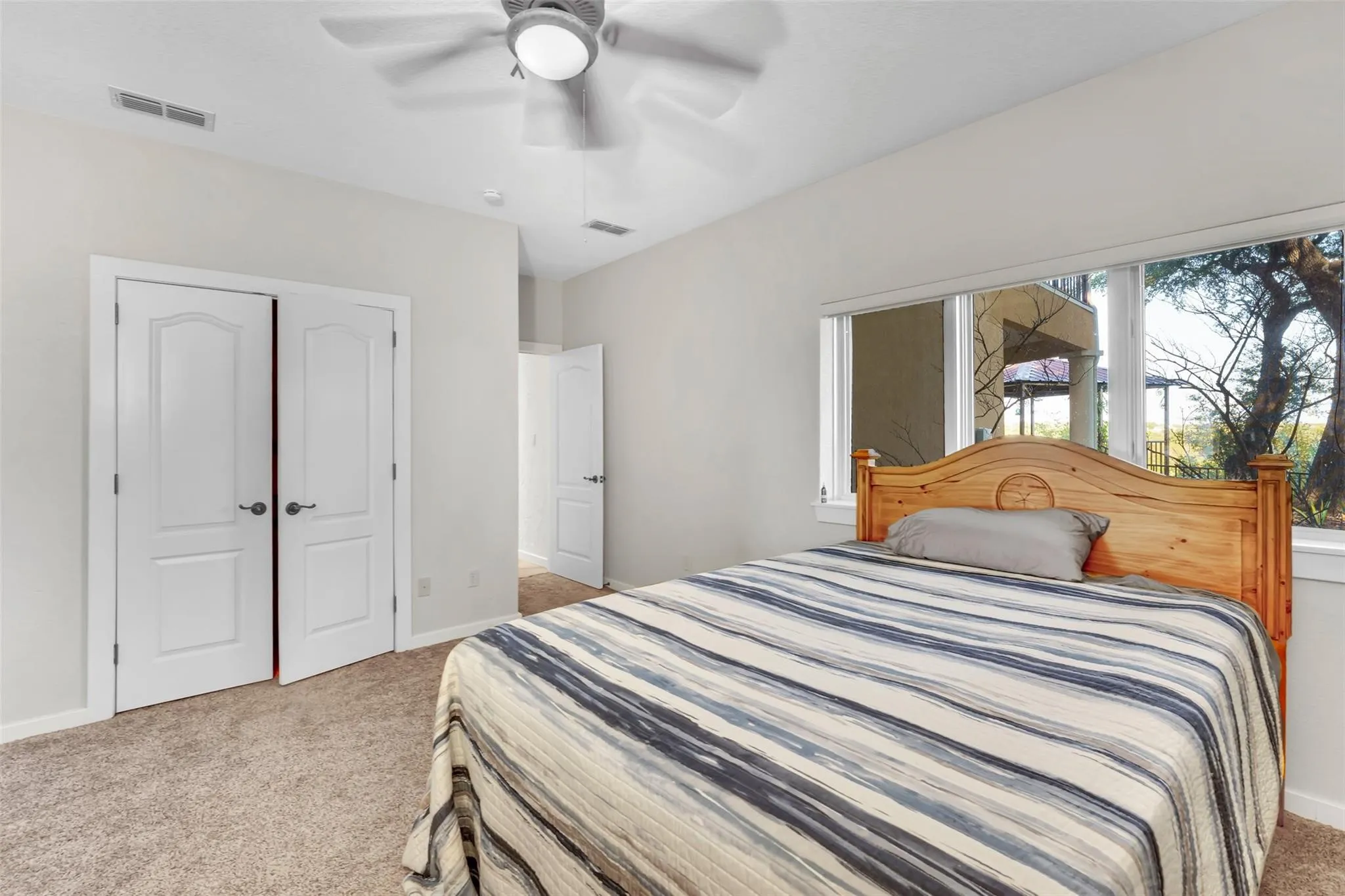 Bedroom featuring carpet flooring, a ceiling fan, and a closet