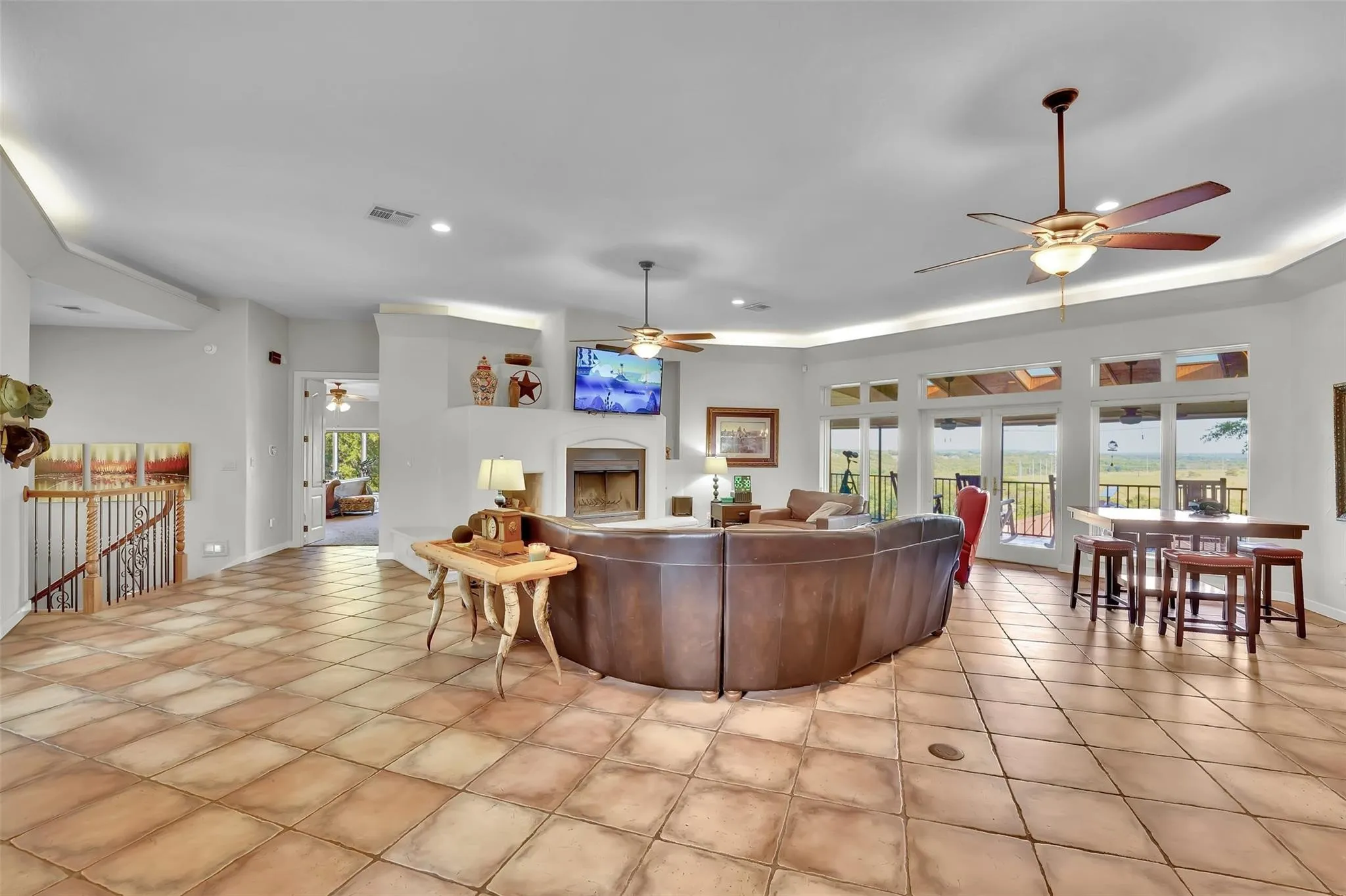 Living room with a ceiling fan, light tile patterned floors, and recessed lighting