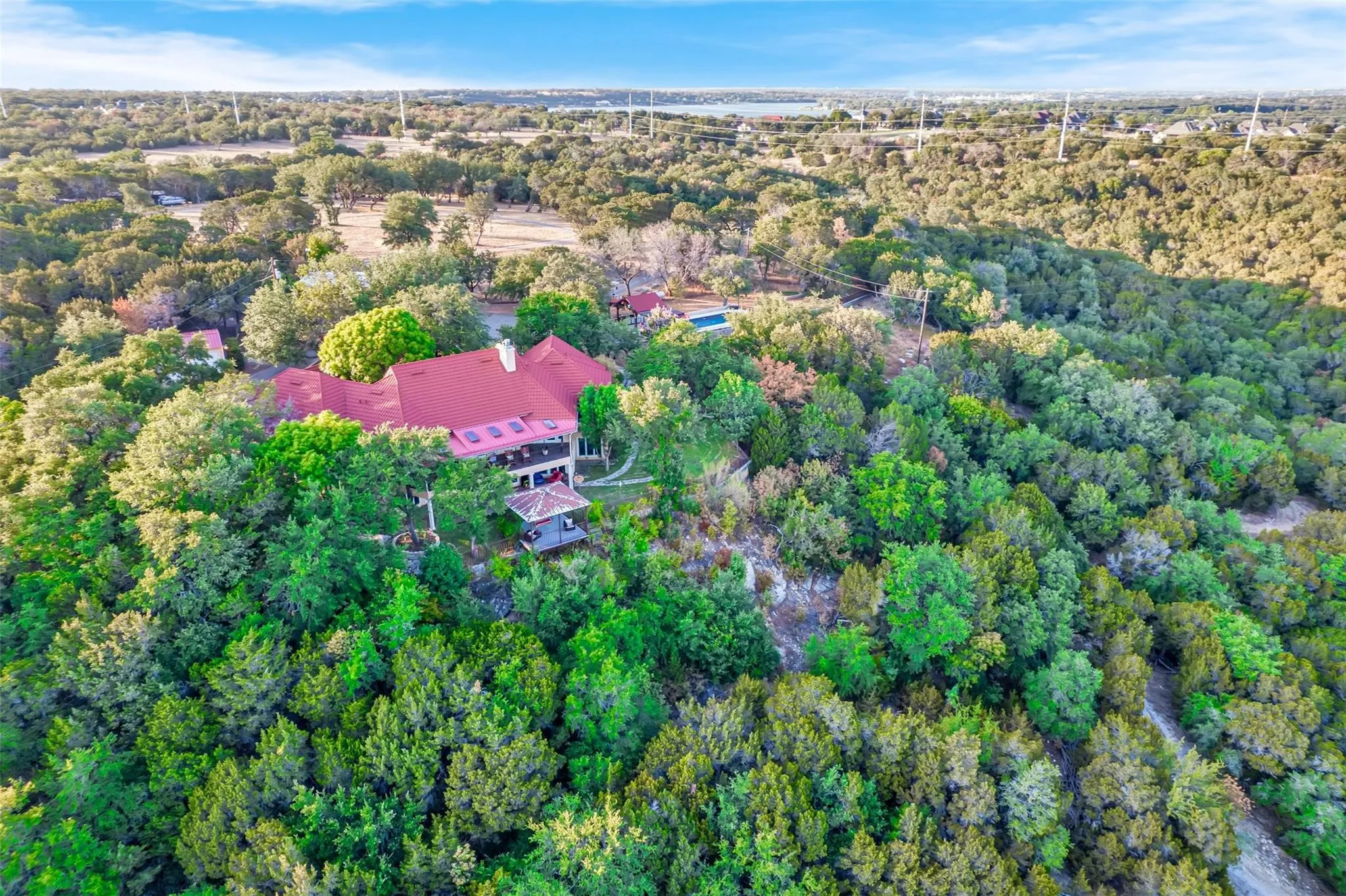 View of property location featuring a forest