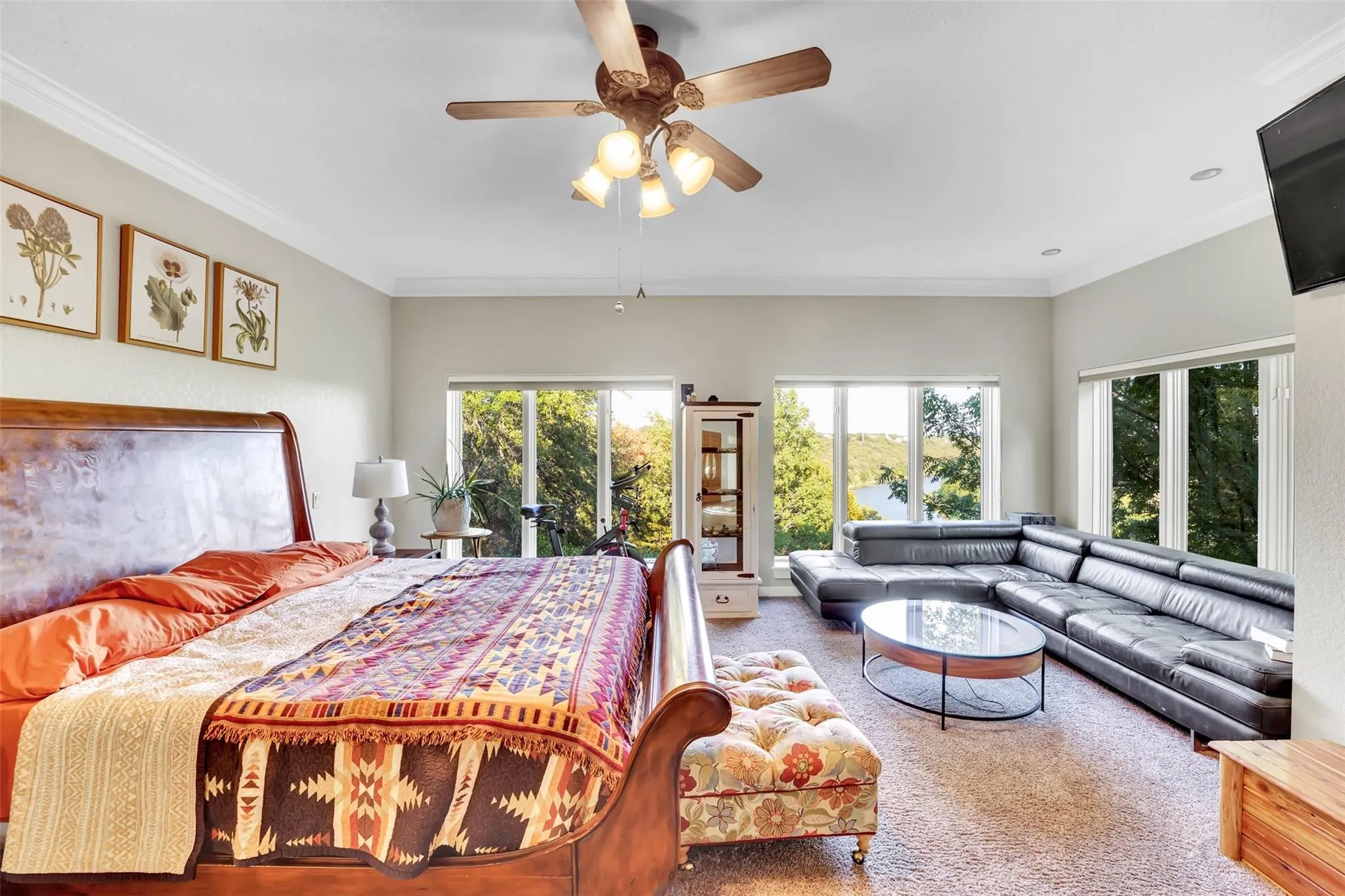 Carpeted bedroom featuring crown molding and ceiling fan