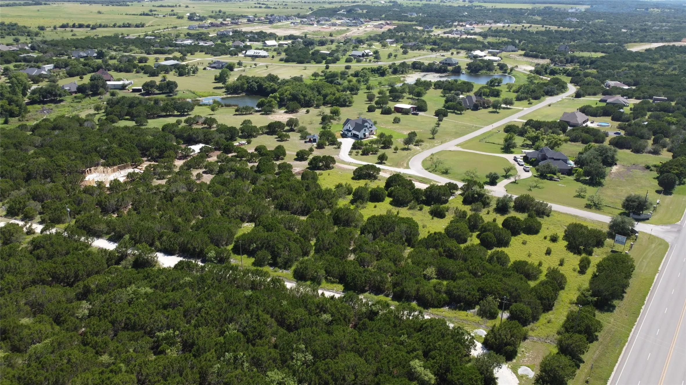 Aerial view of property and surrounding area featuring a nearby body of water