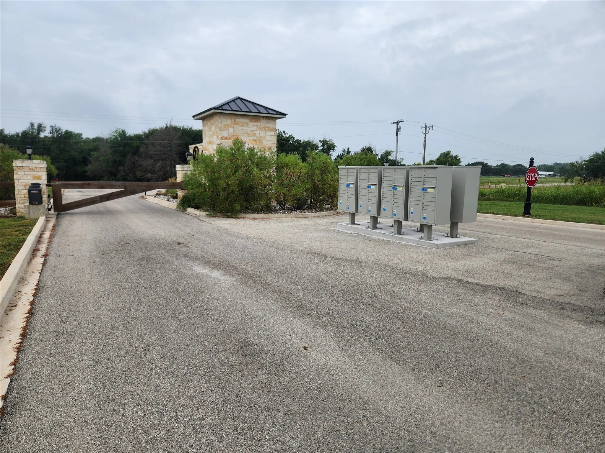 View of asphalt street featuring curbs and personal mailboxes
