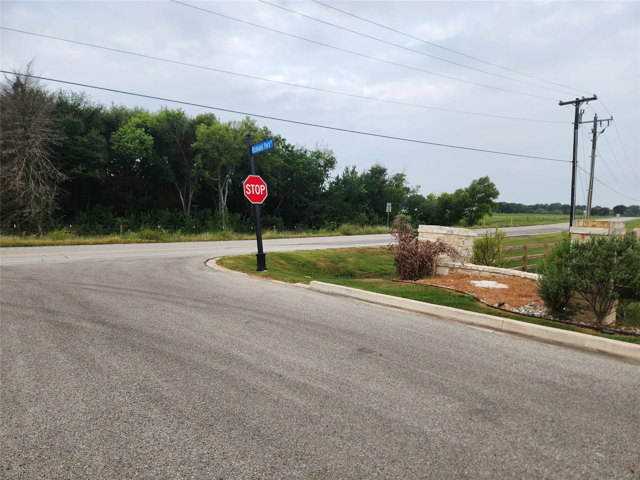 View of asphalt street with traffic sign to FM 637