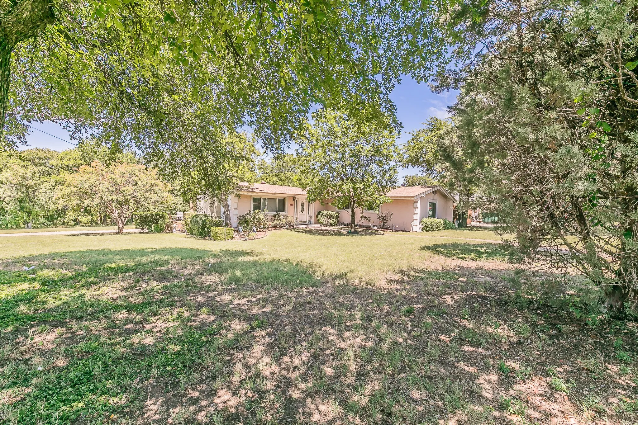 View of front of house with a front lawn and stucco siding