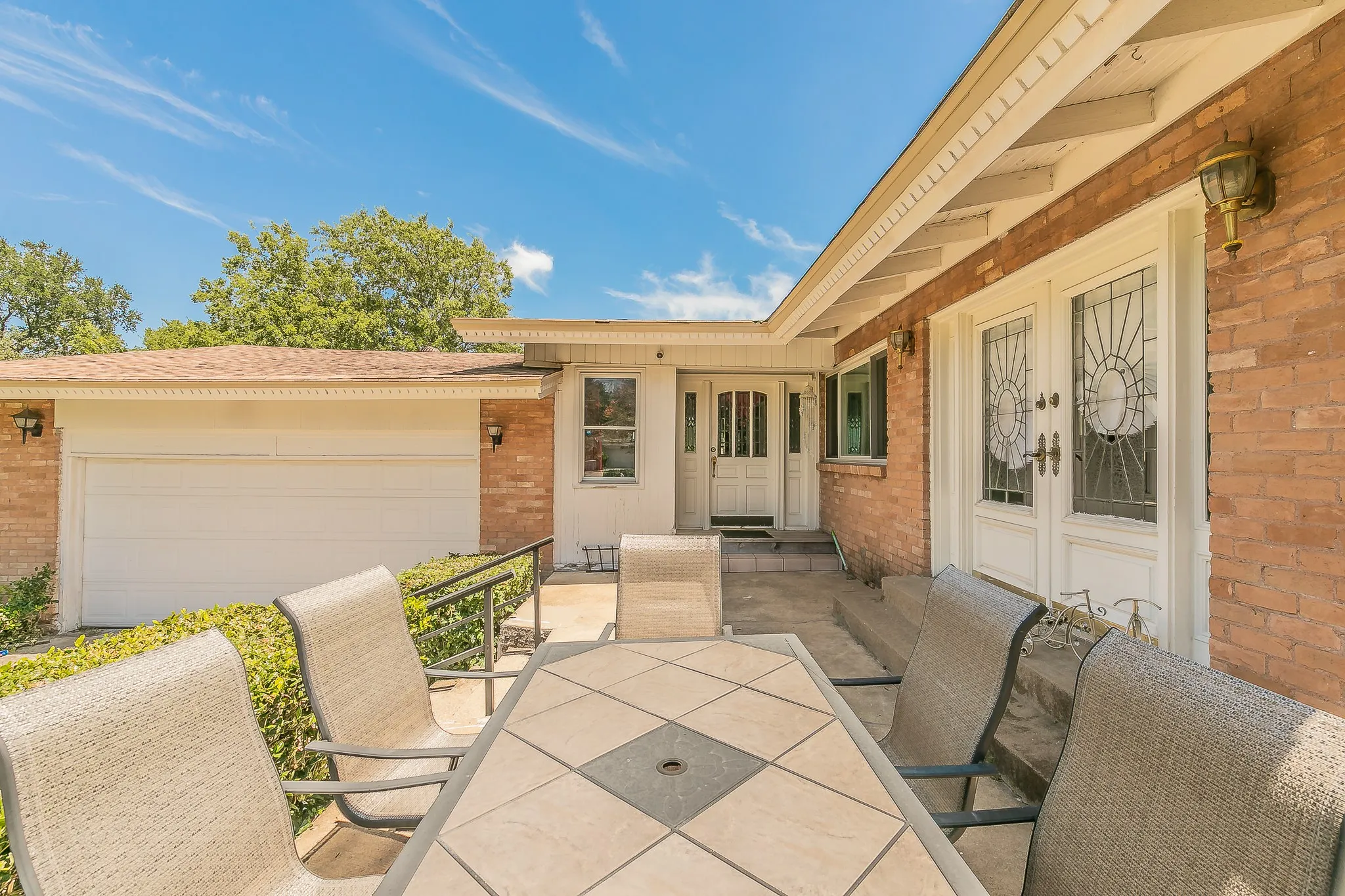 View of patio featuring an attached garage and french doors