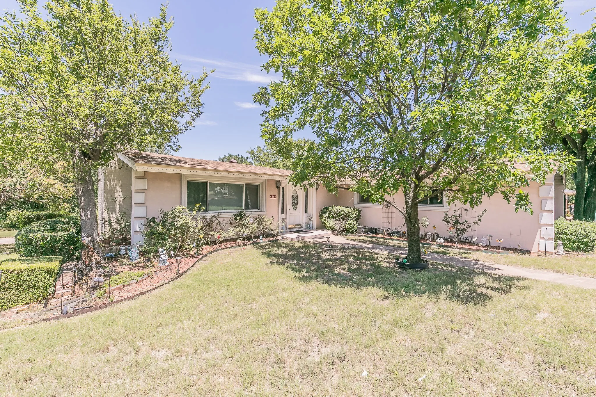 View of front of property with stucco siding and a front yard