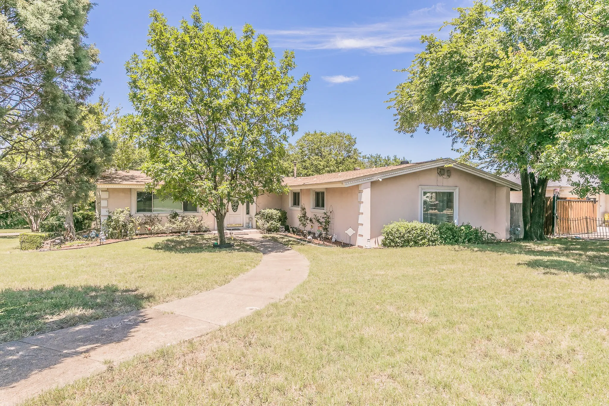 Ranch-style house featuring stucco siding