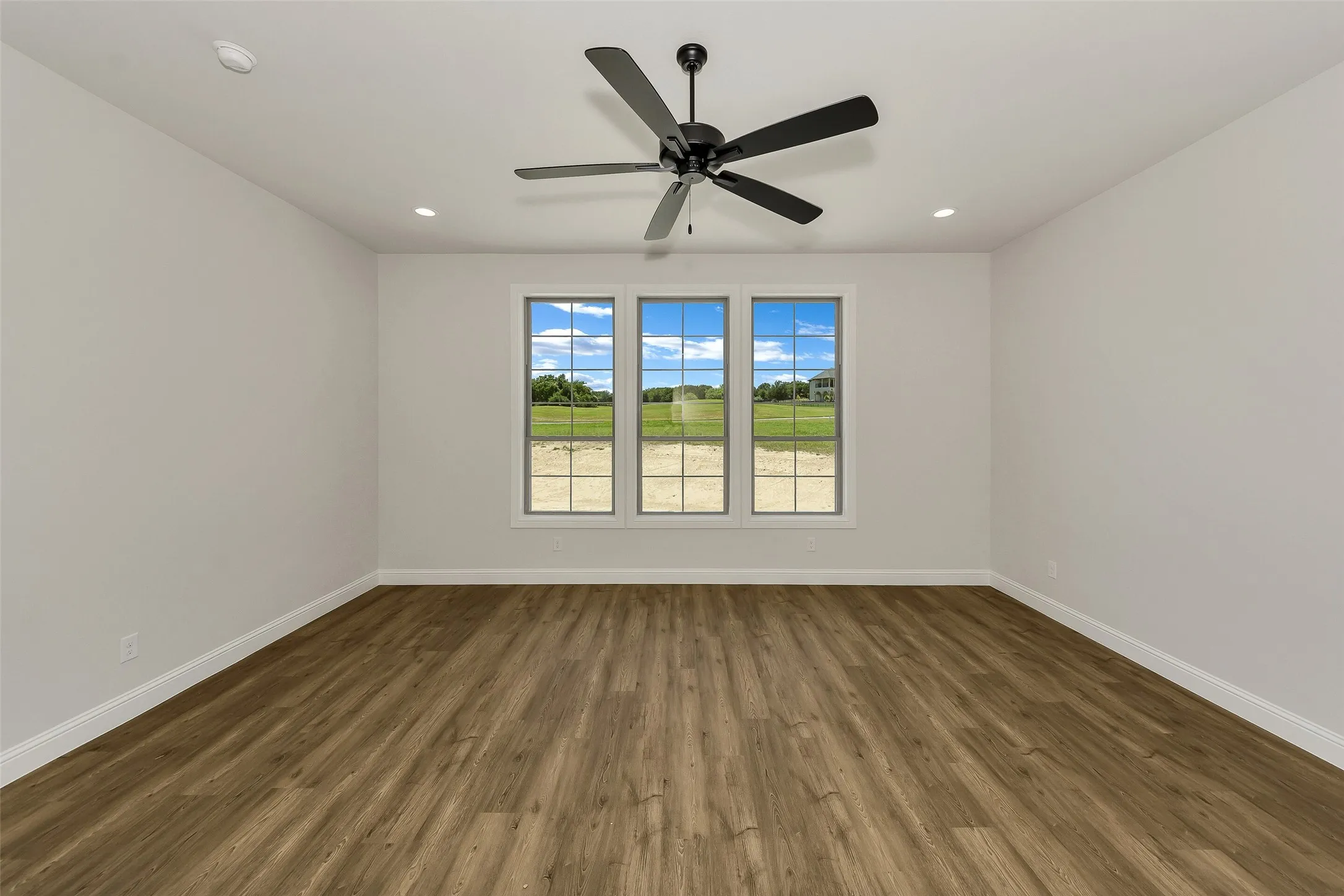 Unfurnished room featuring wood finished floors, ceiling fan, and recessed lighting