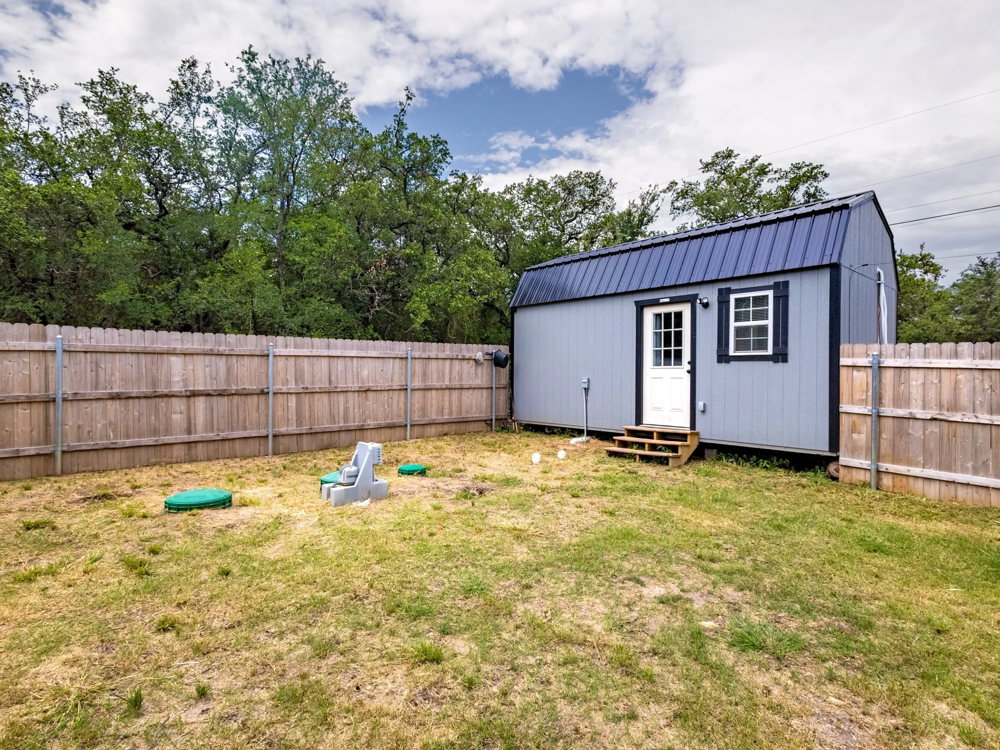 The wooden privacy fence encloses the backyard.