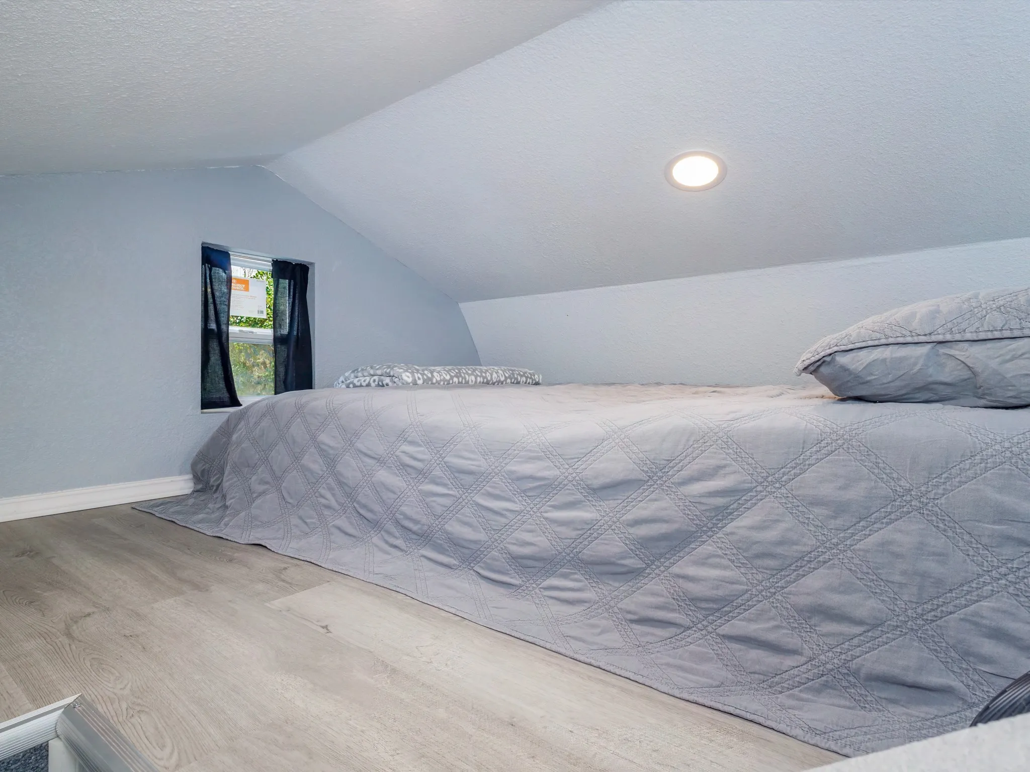 Sleeping loft adds extra space for guests or storage, maximizing the use of the cozy interior.