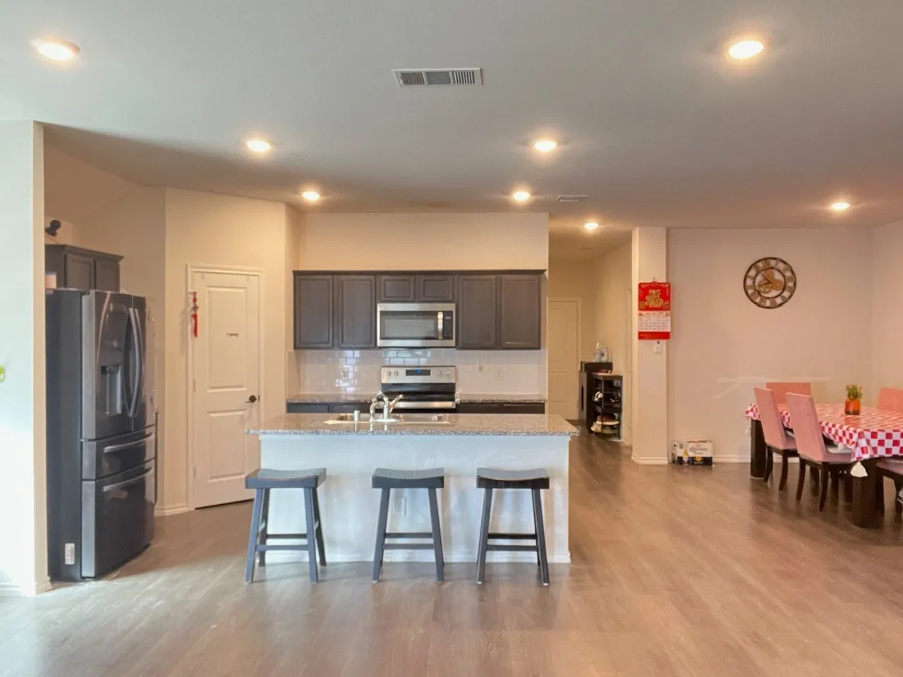 Kitchen featuring refrigerator, tasteful backsplash, a breakfast bar, range, and recessed lighting