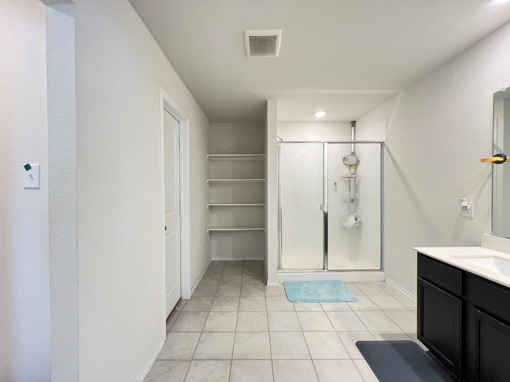 Full bath with a shower stall, vanity, tile patterned floors, and recessed lighting
