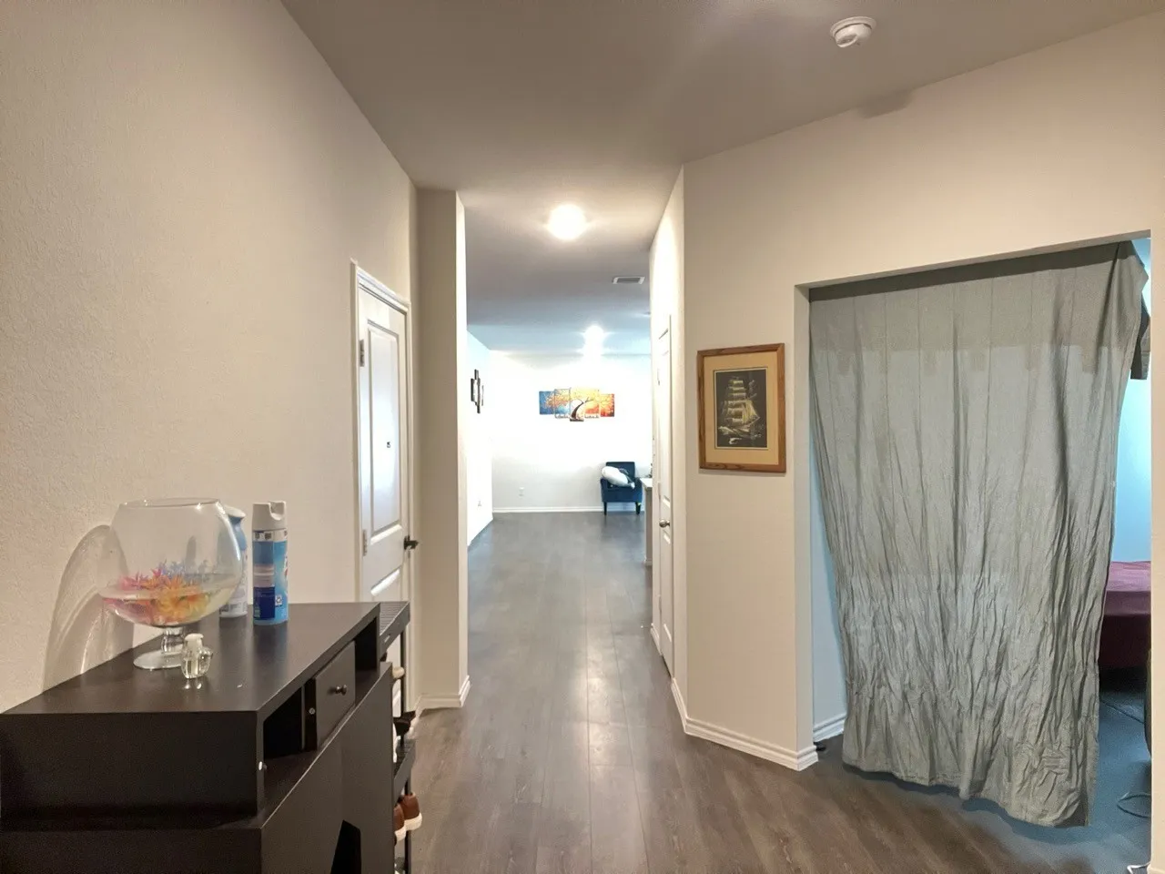 Hall with dark wood finished floors and baseboards