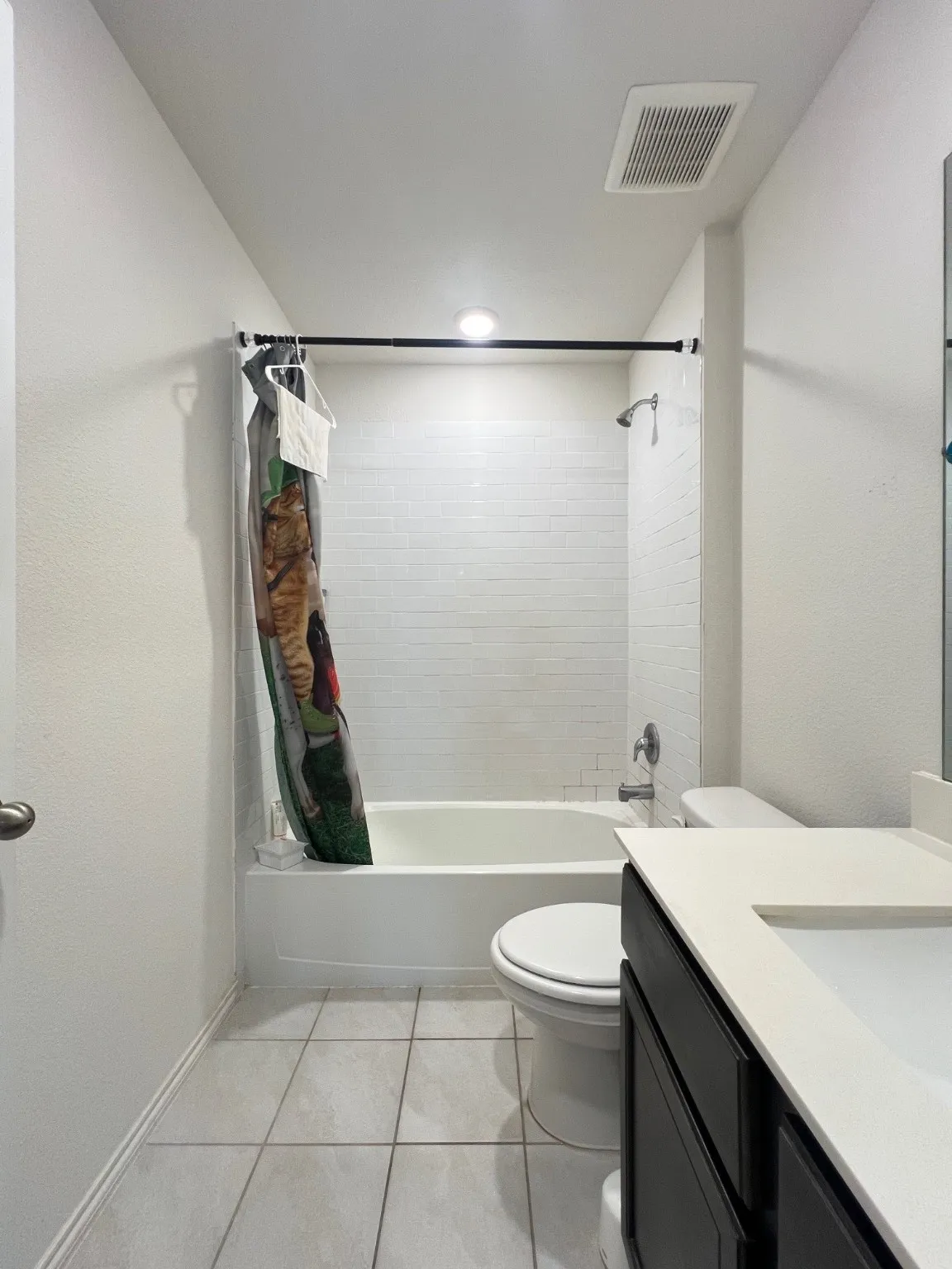 Full bath featuring shower / bath combination with curtain, vanity, and tile patterned flooring