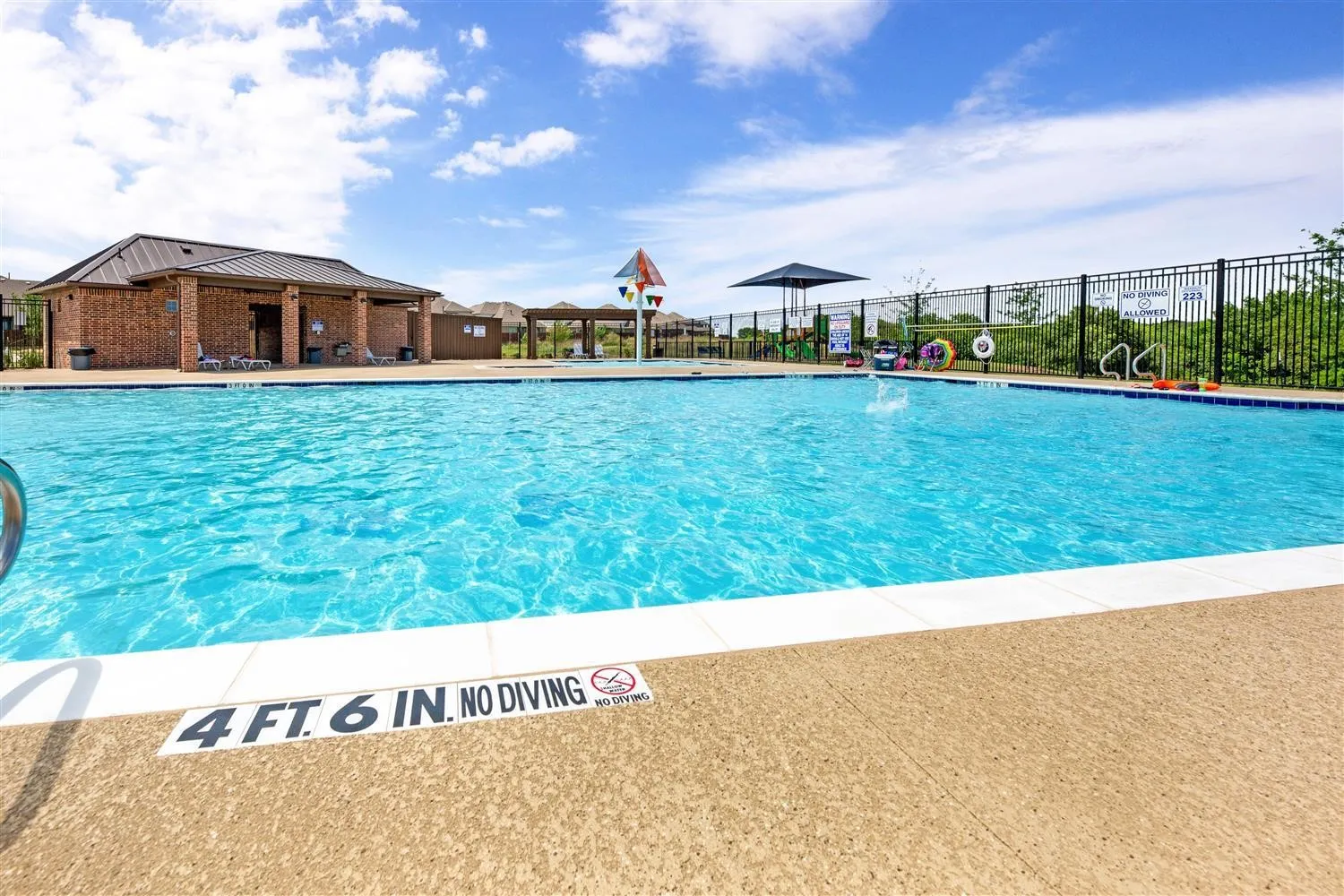 Community pool featuring a patio