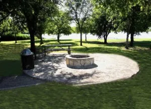 View of home's community with a lawn and a fire pit