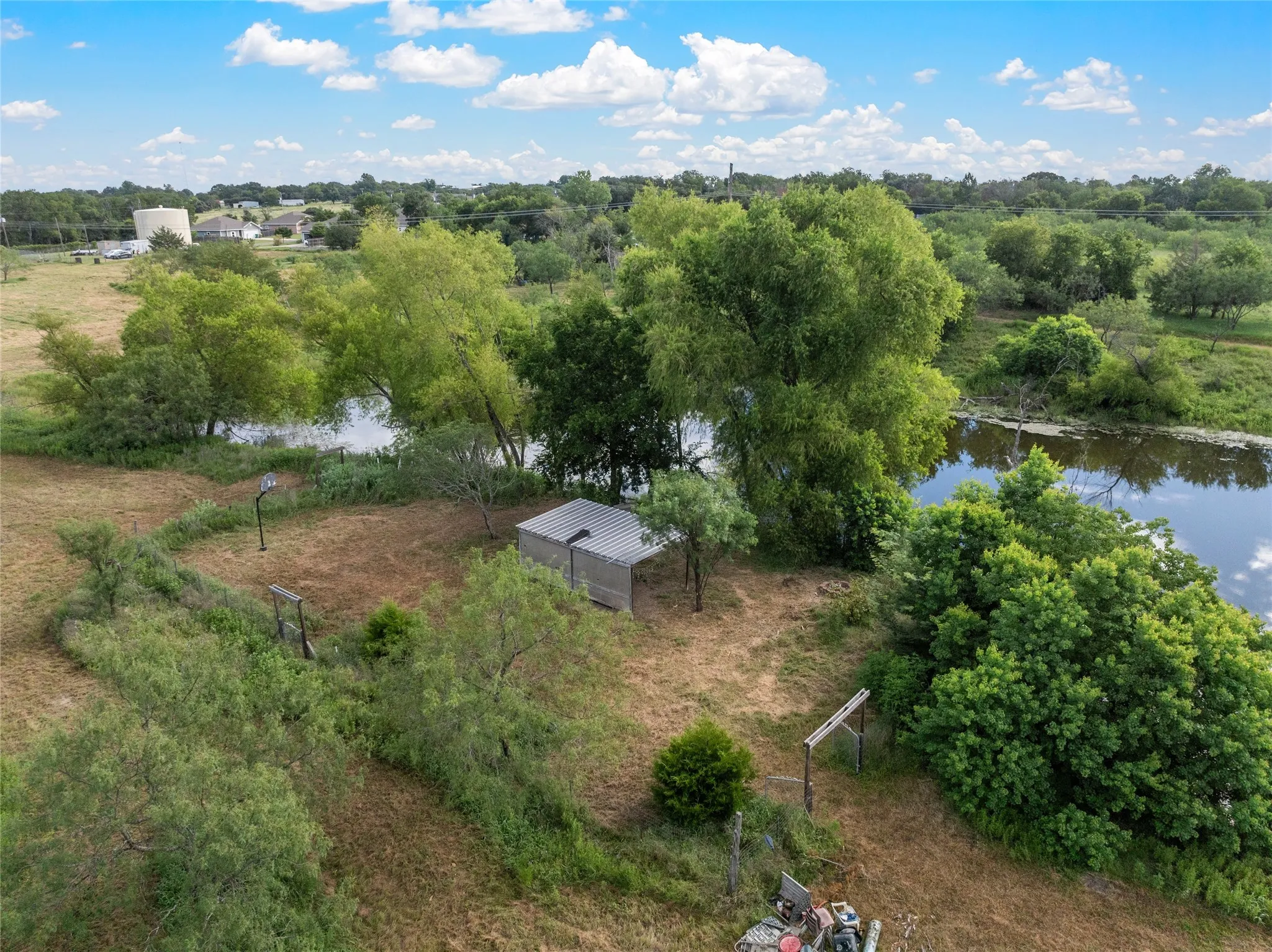 Cross fenced entertaining area near tank/pond