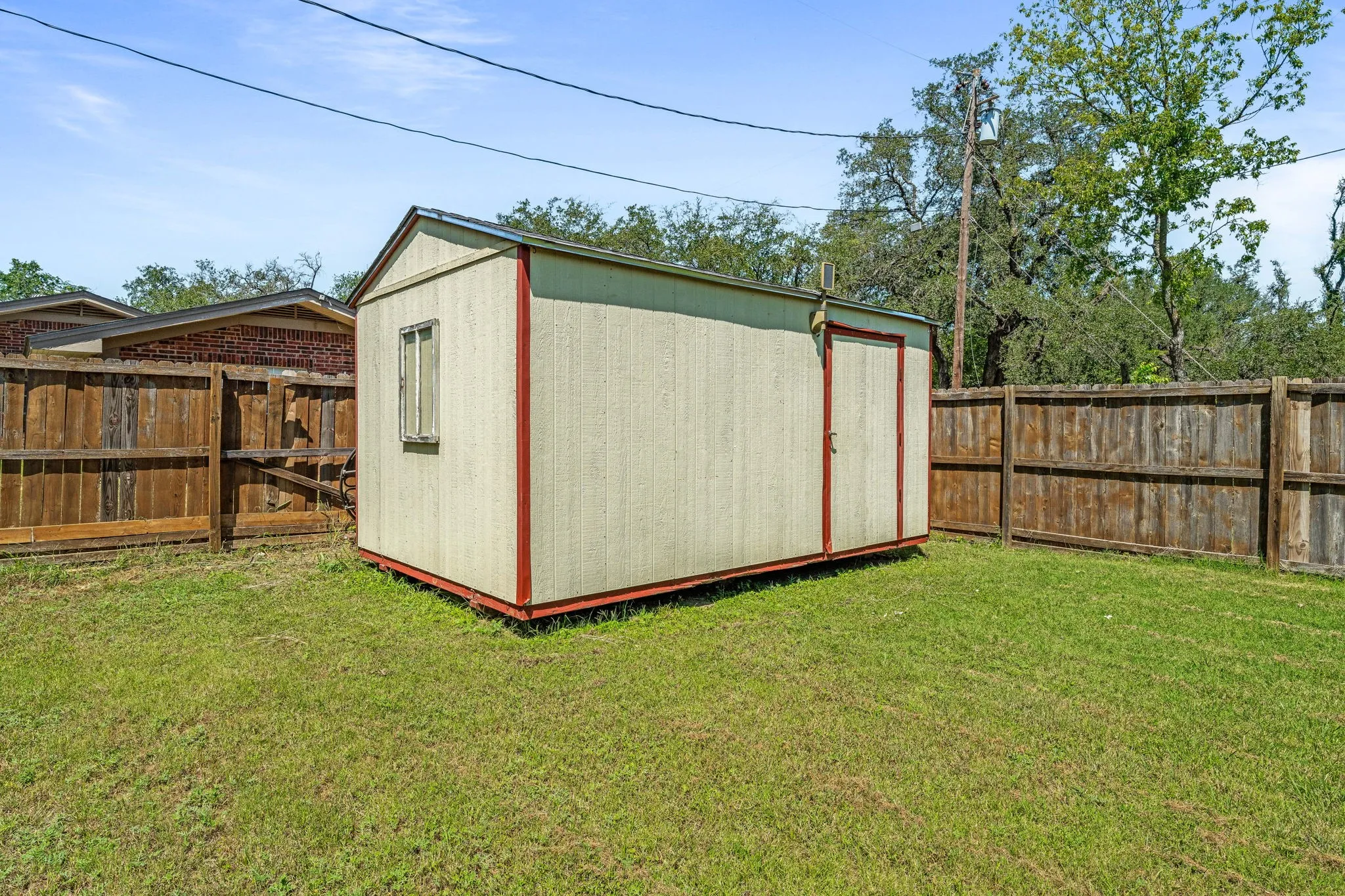 View of shed featuring a fenced backyard