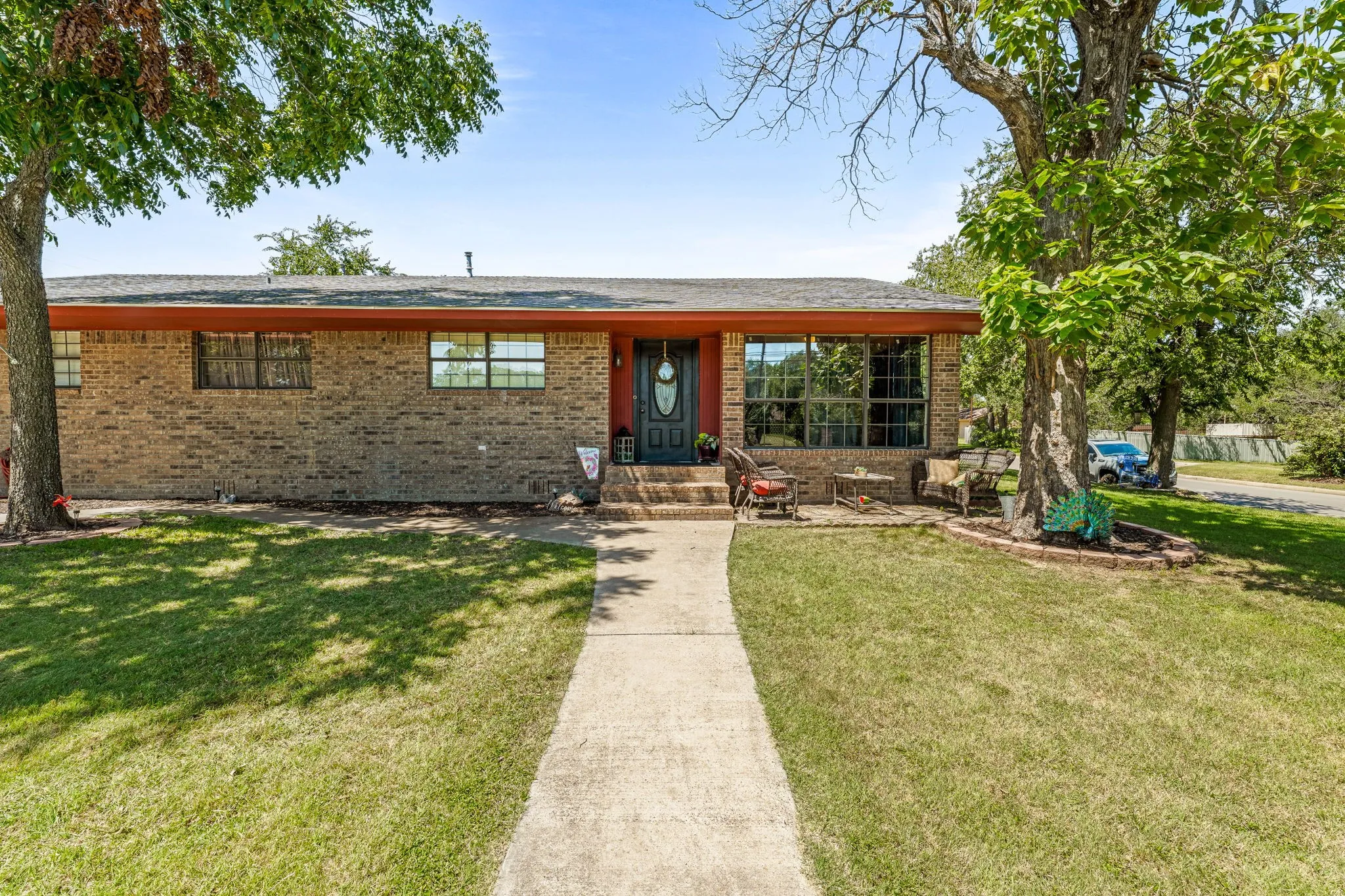 Ranch-style house featuring brick siding and a front yard