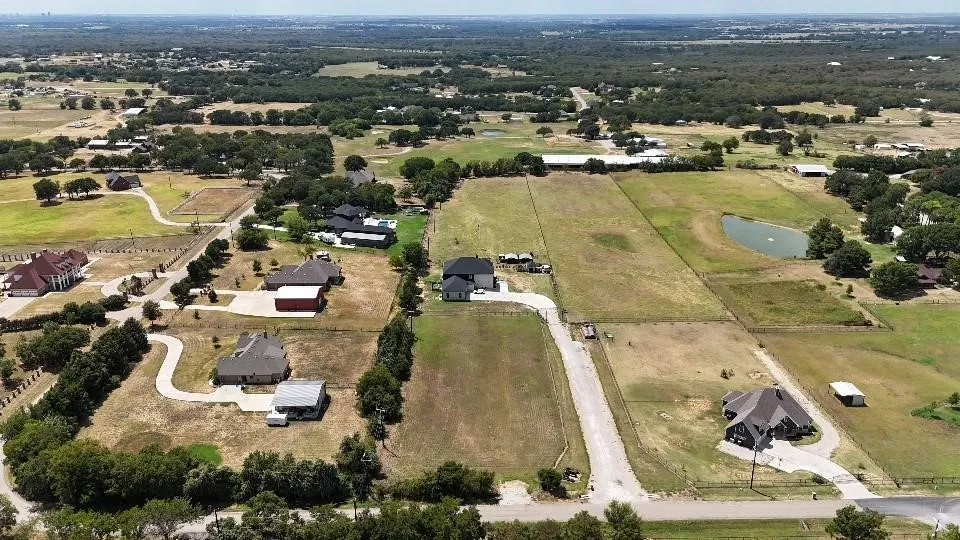 Aerial view of property and surrounding area featuring a nearby body of water