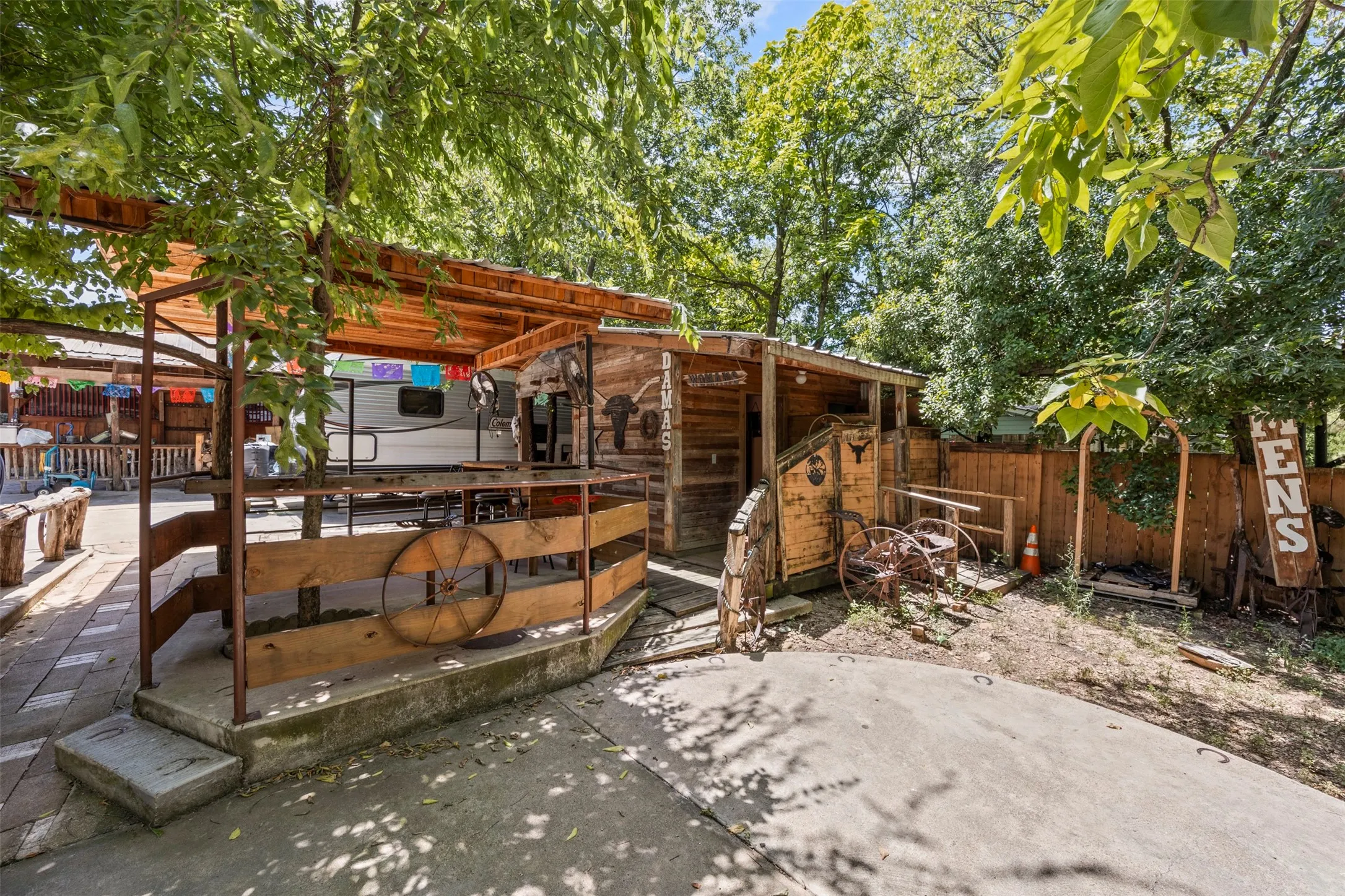 Fenced backyard featuring a patio and an outdoor structure