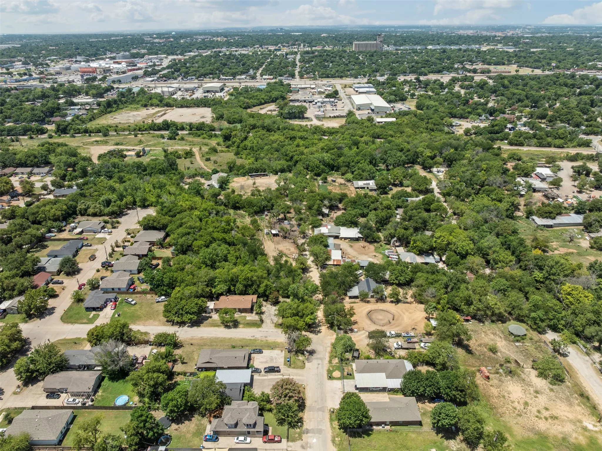 Aerial perspective of suburban area featuring a tree filled landscape