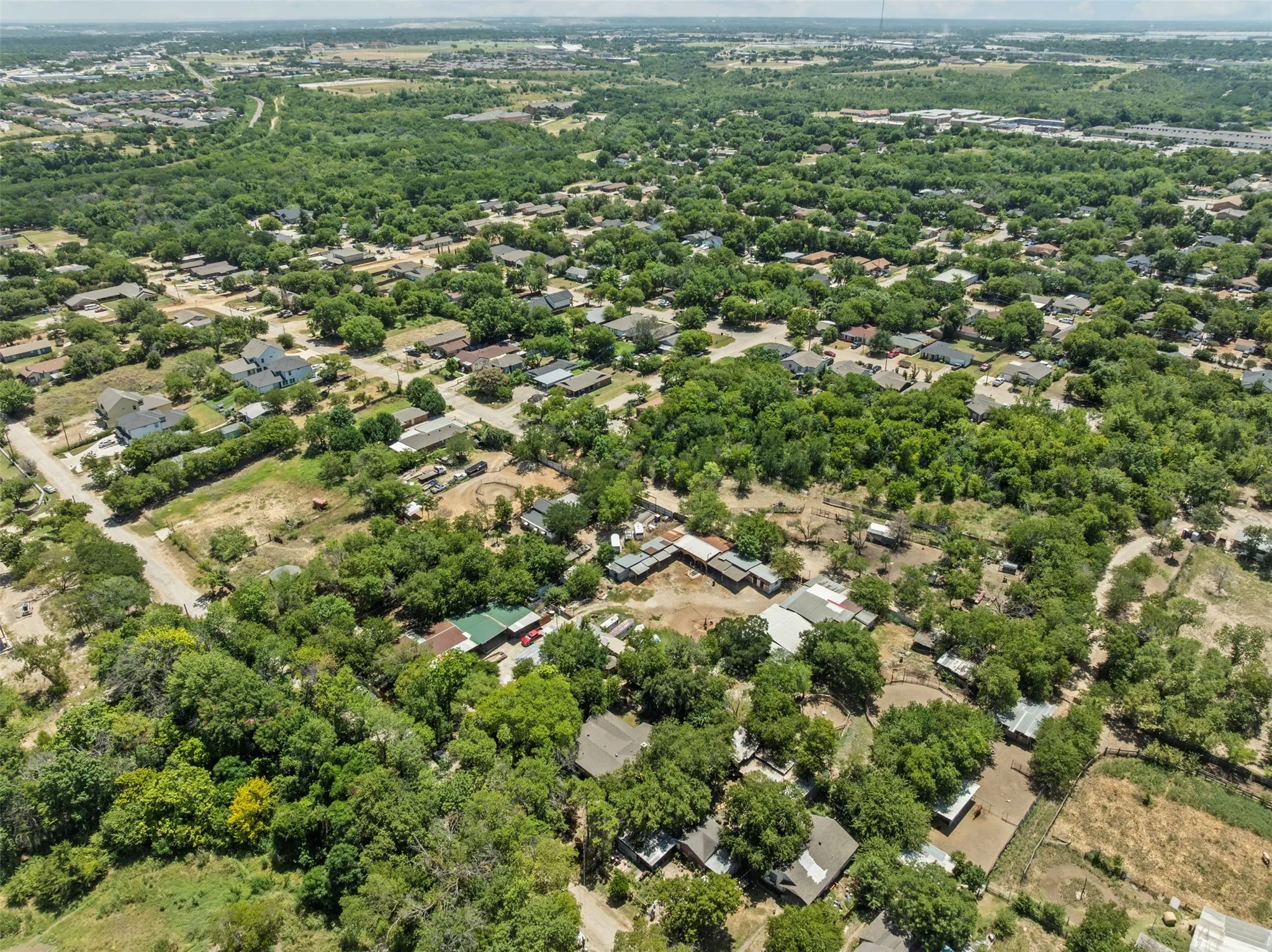 Aerial perspective of suburban area with a tree filled landscape