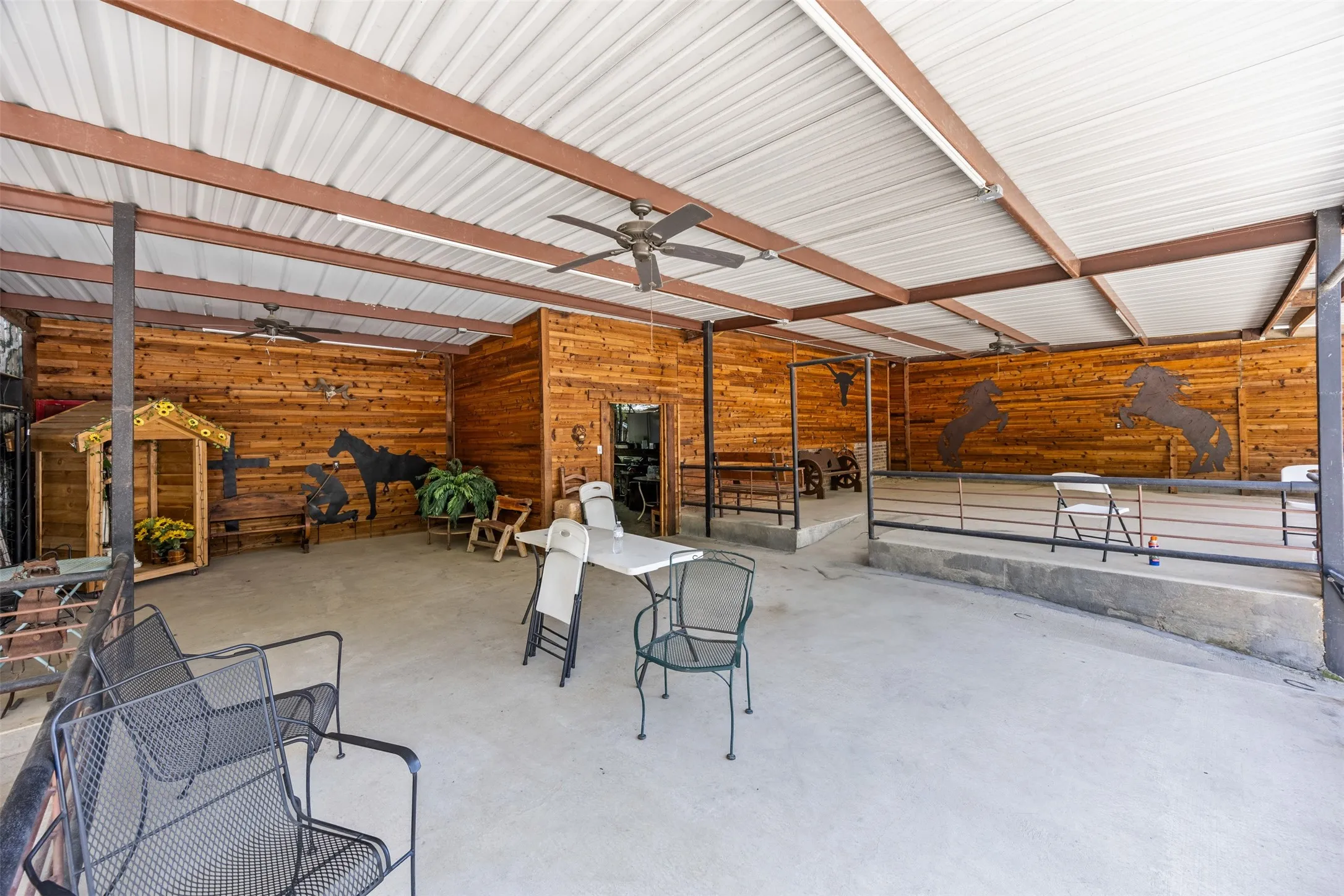 Garage with wood walls and ceiling fan