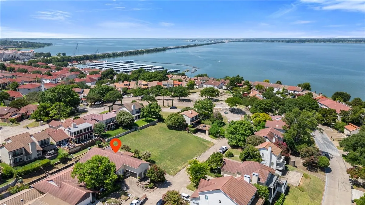 Aerial view of residential area featuring a large body of water and a notable bridge