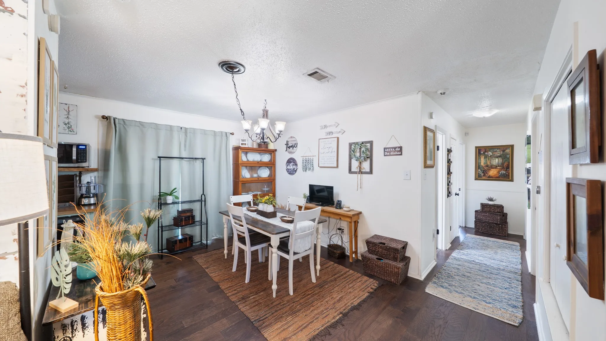 Wood-finish flooring throughout, white walls, and a recessed ceiling light fixture